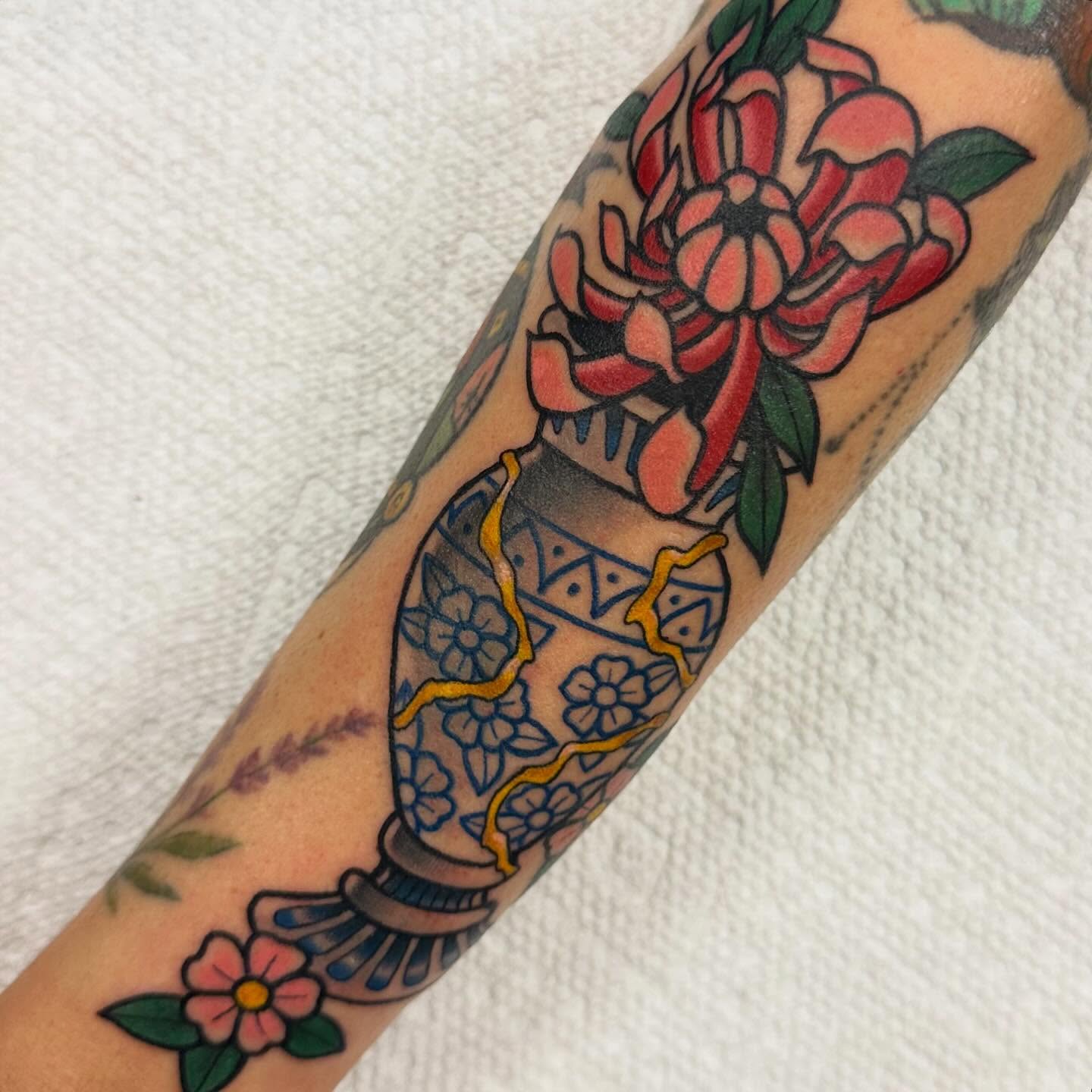 Floral arrangement American traditional tattoo on the forearm by Katie Beth
