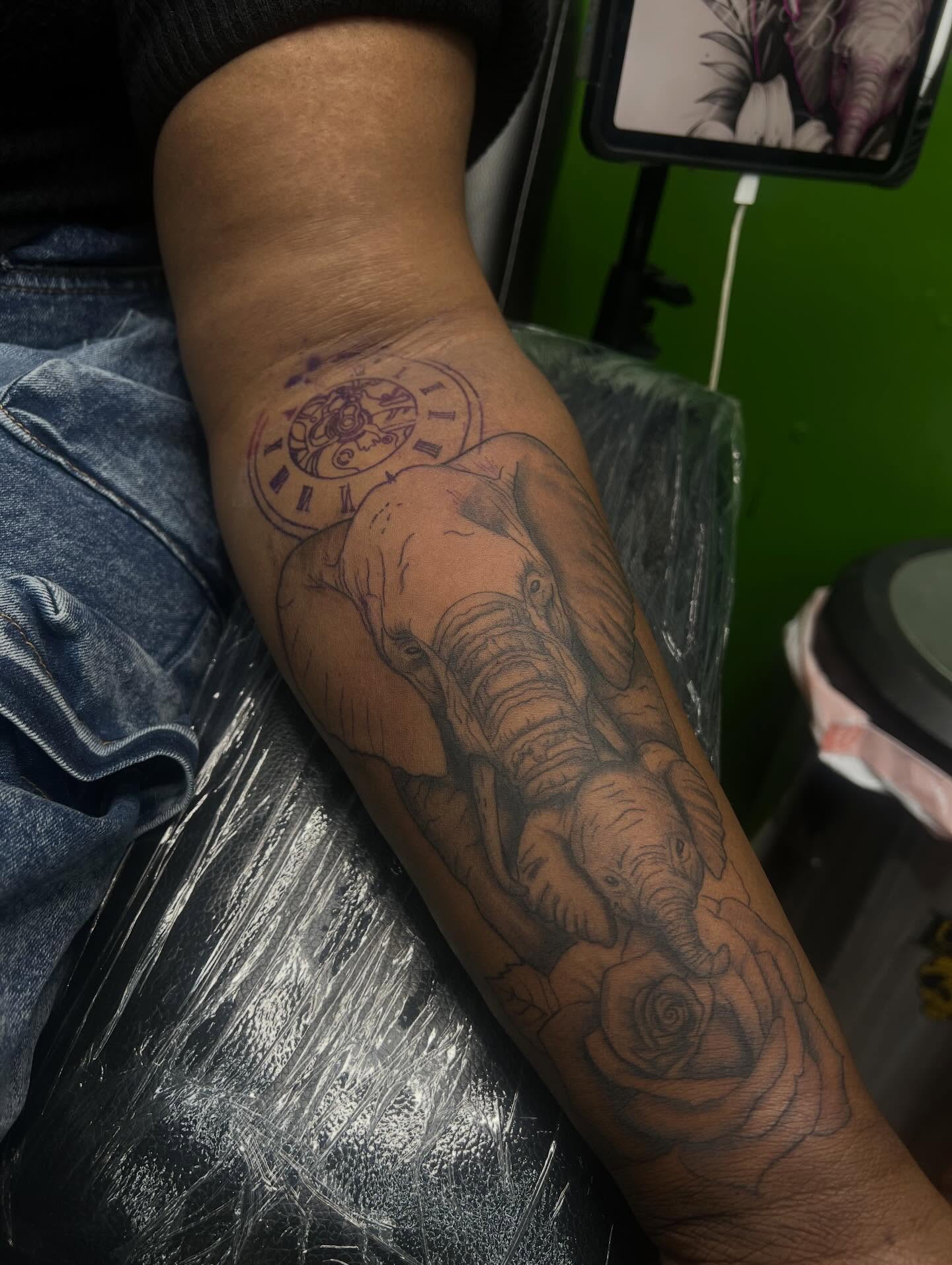 Elephants and roses realism tattoo on the forearm by Glass Inkk