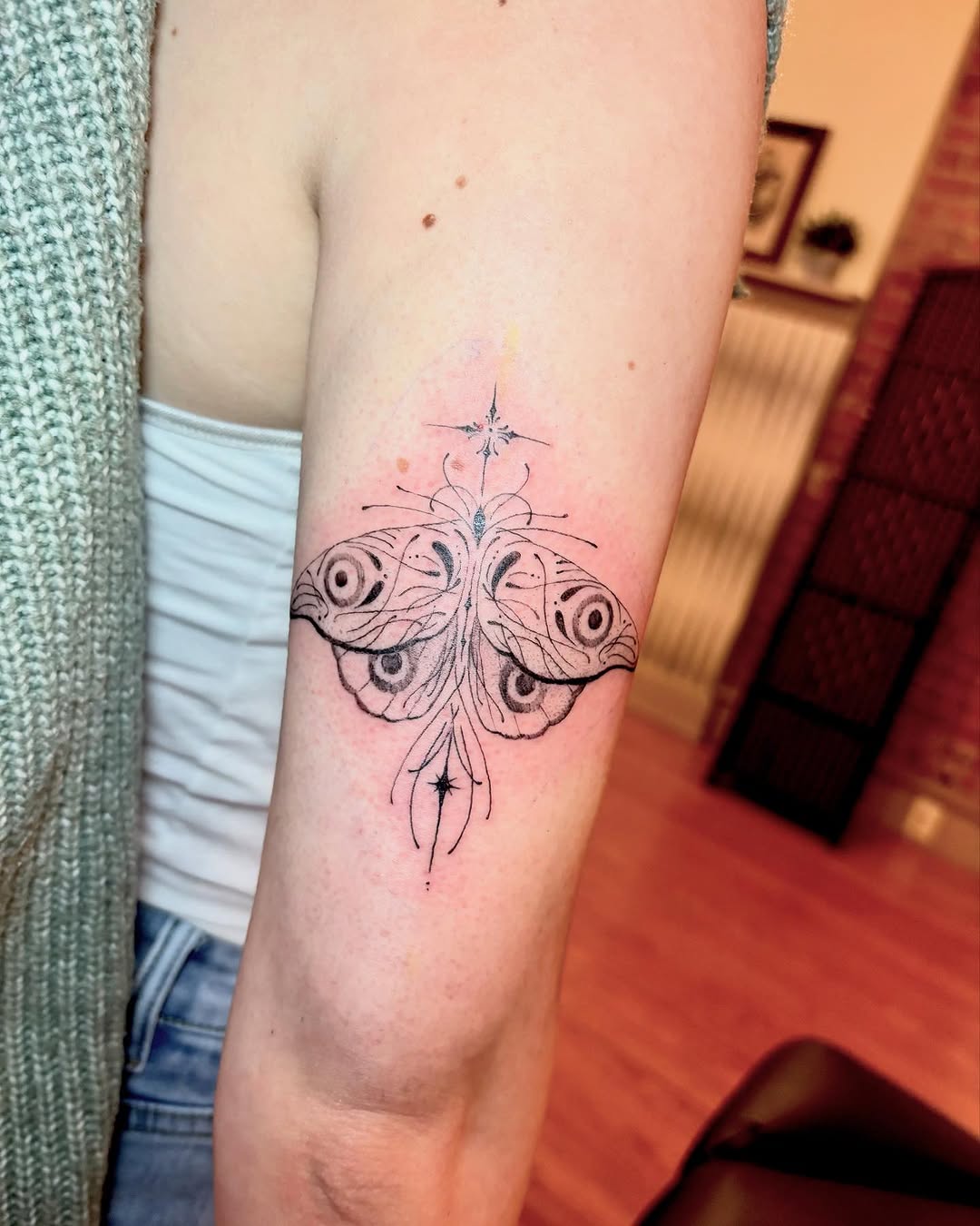 Moth with celestial elements fine line tattoo on the forearm by madison, Cincinnati