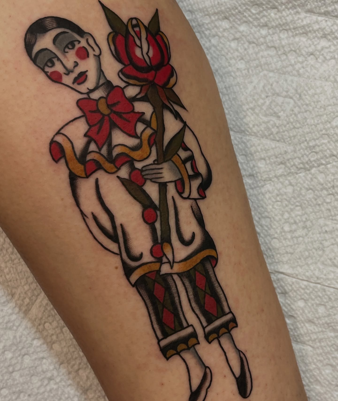 Clown with rose American traditional tattoo on the thigh by August B., Renton, Washington