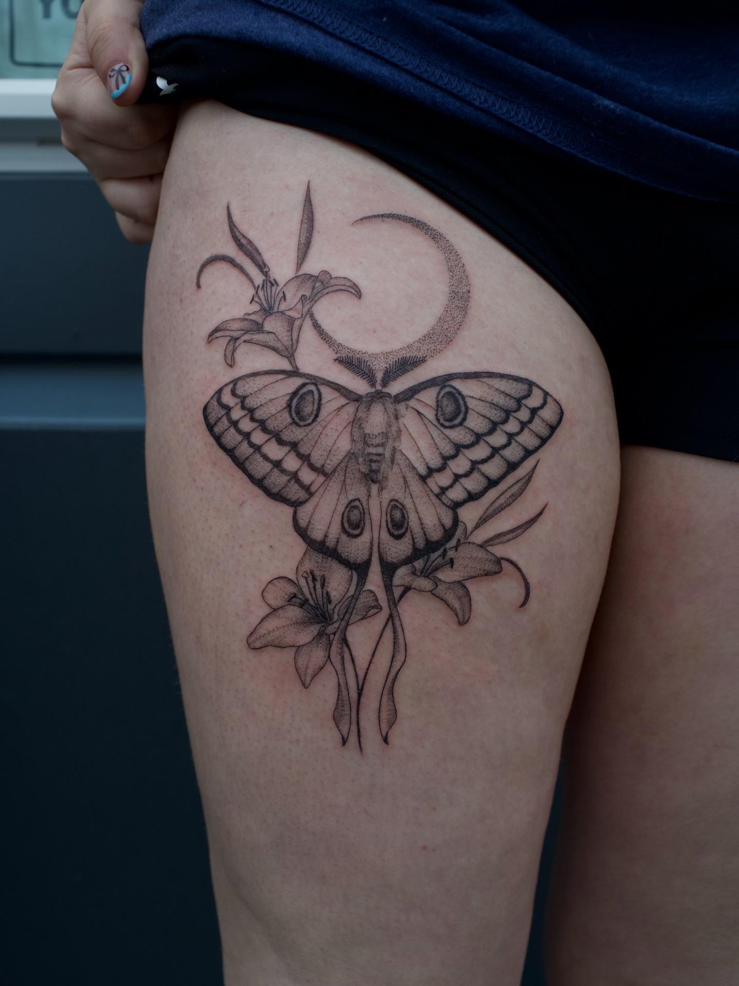 Moth and flowers realism tattoo on the thigh by Kevin Rotramel, Dayton, Ohio