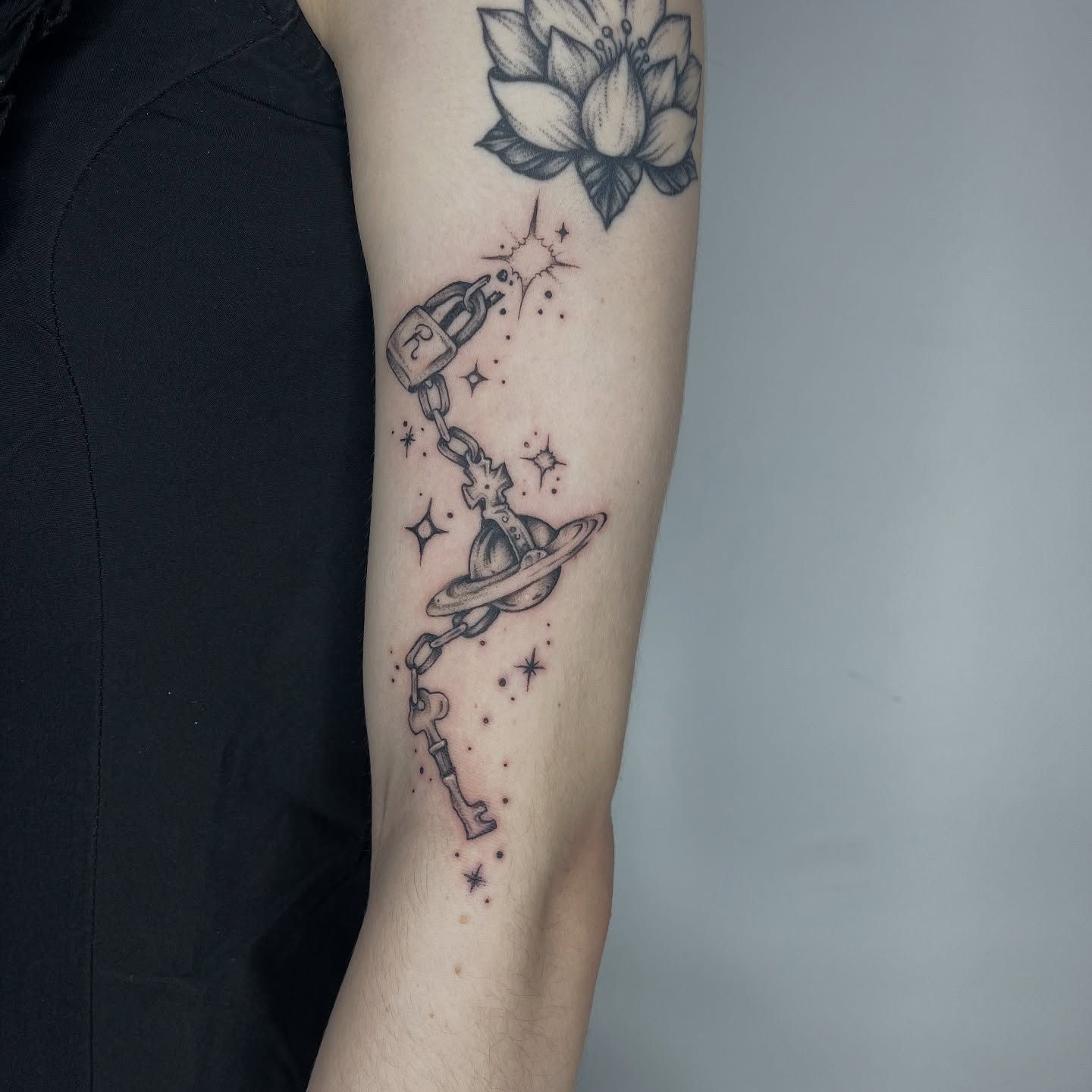 Key and planet black and grey tattoo on the forearm by ✨ Chris ✨