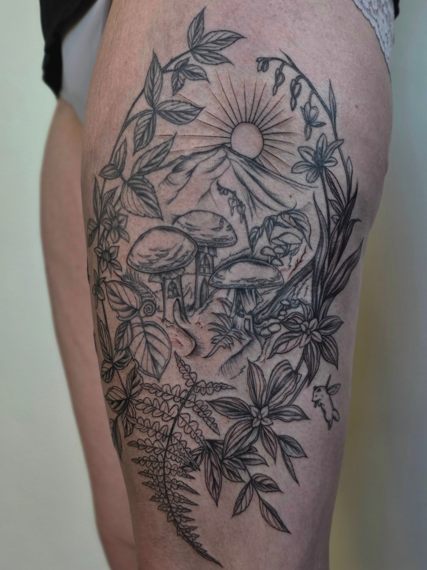 Mushroom forest realism tattoo on the thigh by Sierra (cc) Klein