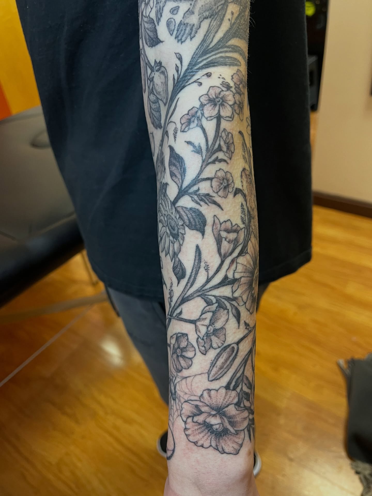 Floral design black and grey tattoo on the forearm by Gianna Calisi