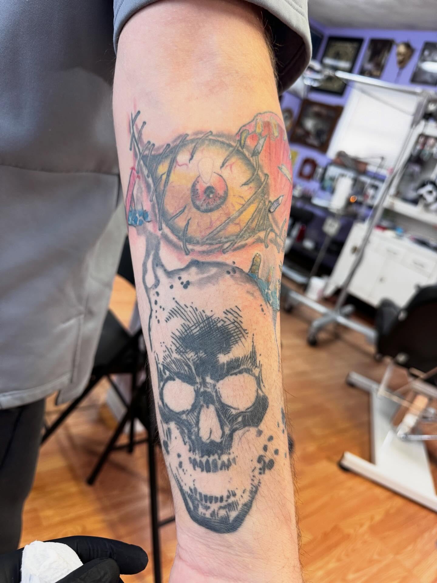 Skull and eyeball realism tattoo on the forearm by Justin Fiveson