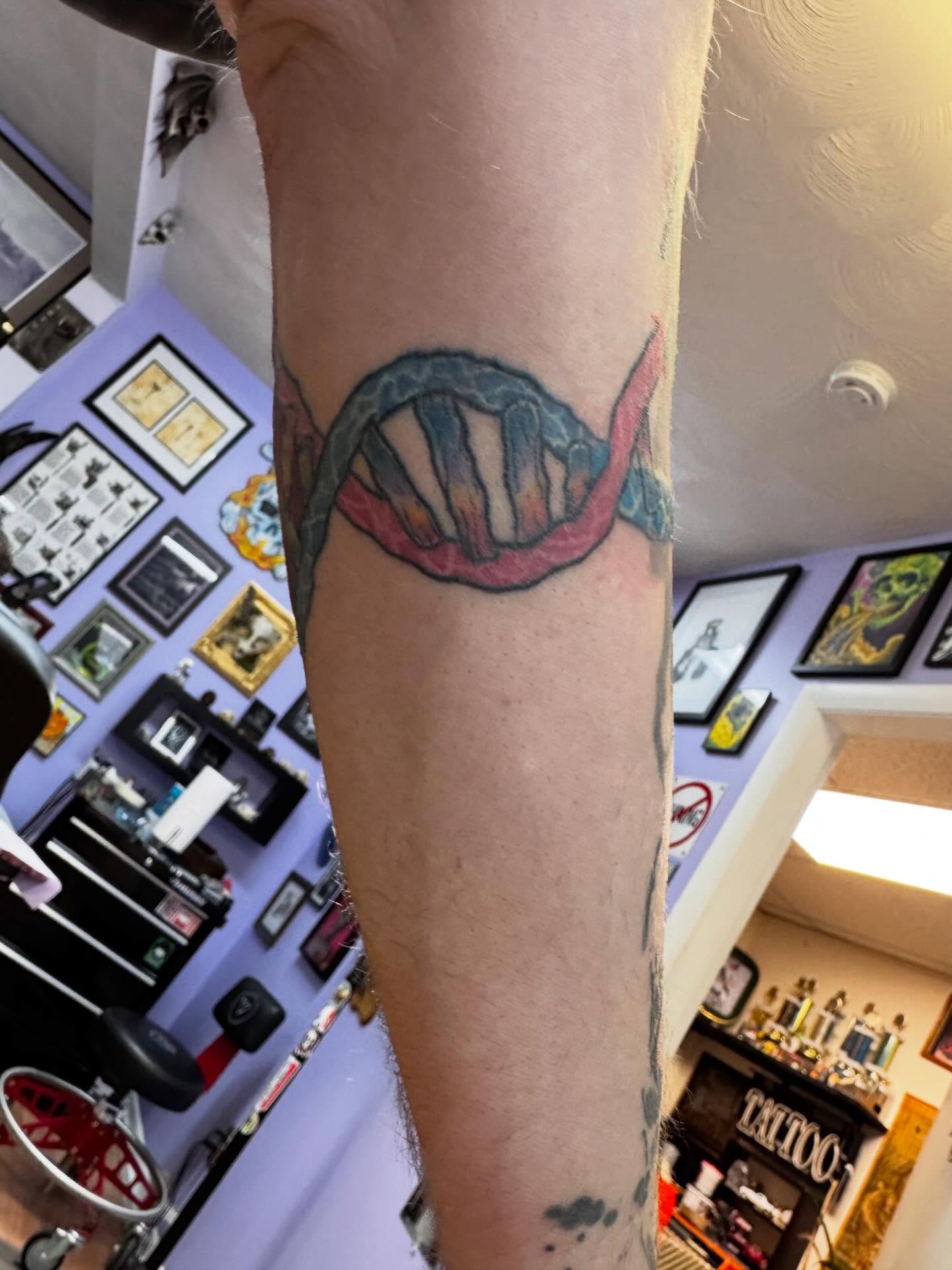 DNA strand realism tattoo on the forearm by Justin Fiveson