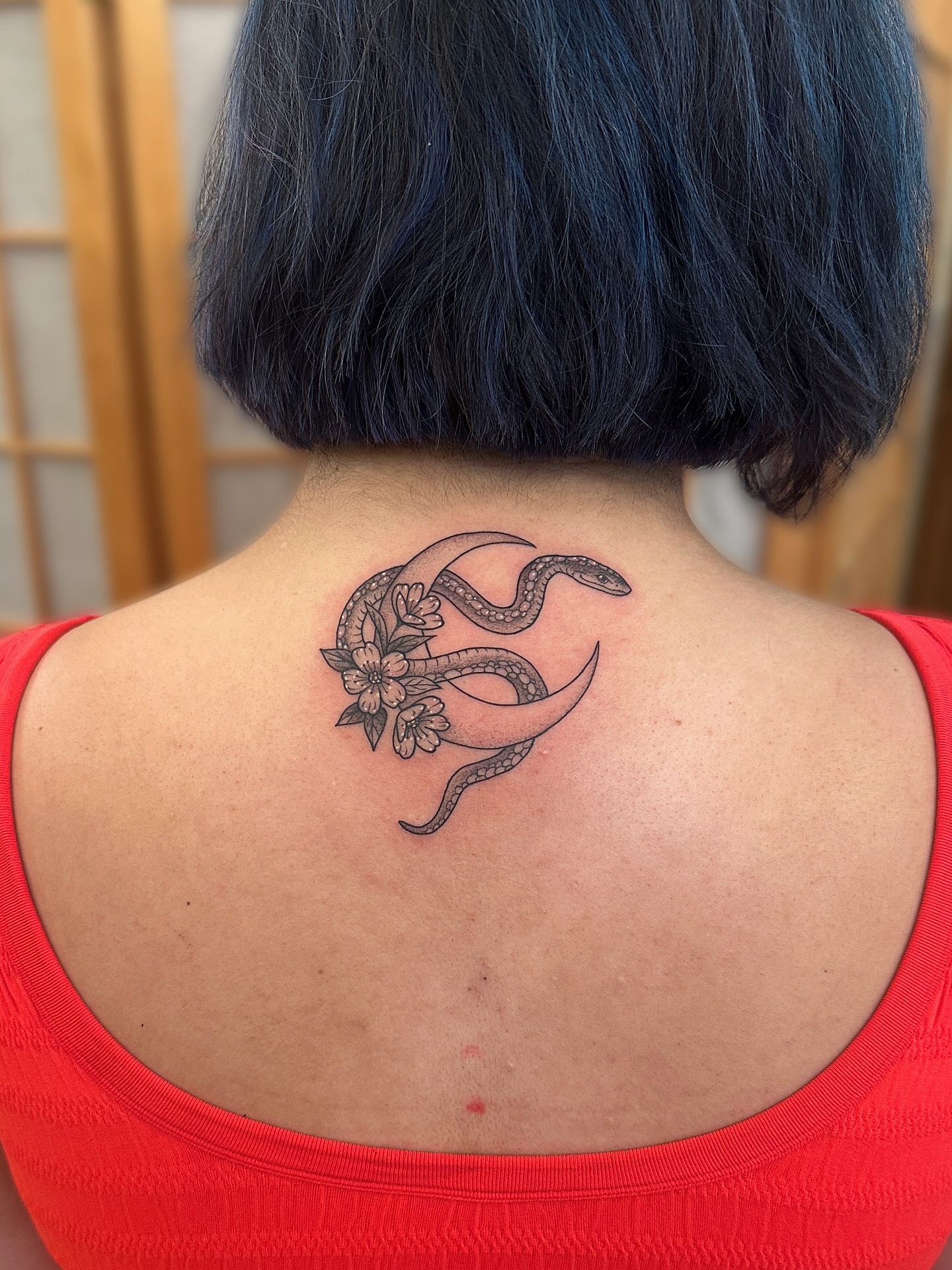 Snake and flowers black and grey tattoo on the back by Tattooing by Patty Valentine