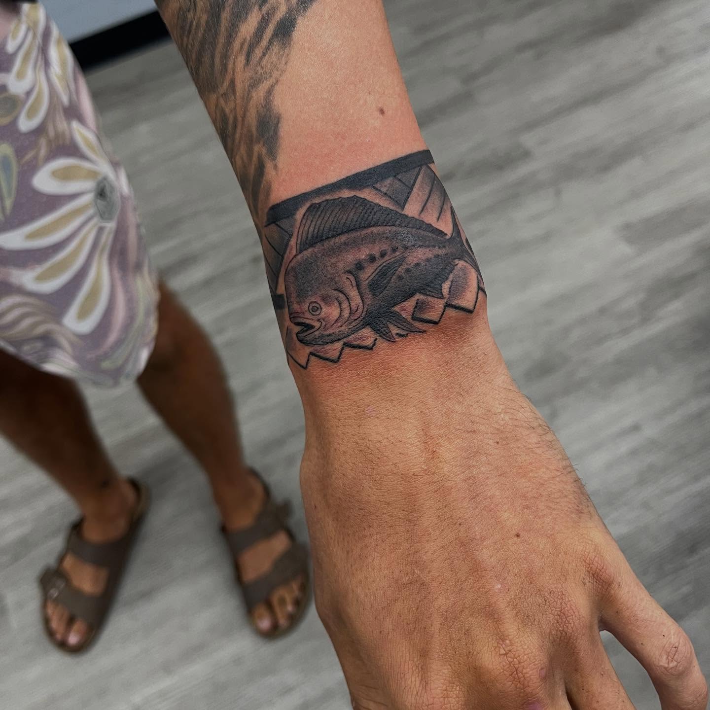 Fish black and grey tattoo on the forearm by Franky Sharpz