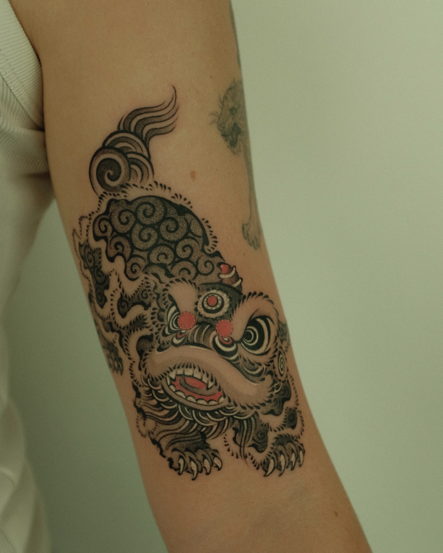 Lion japanese irezumi tattoo on the forearm by Xiao Lun