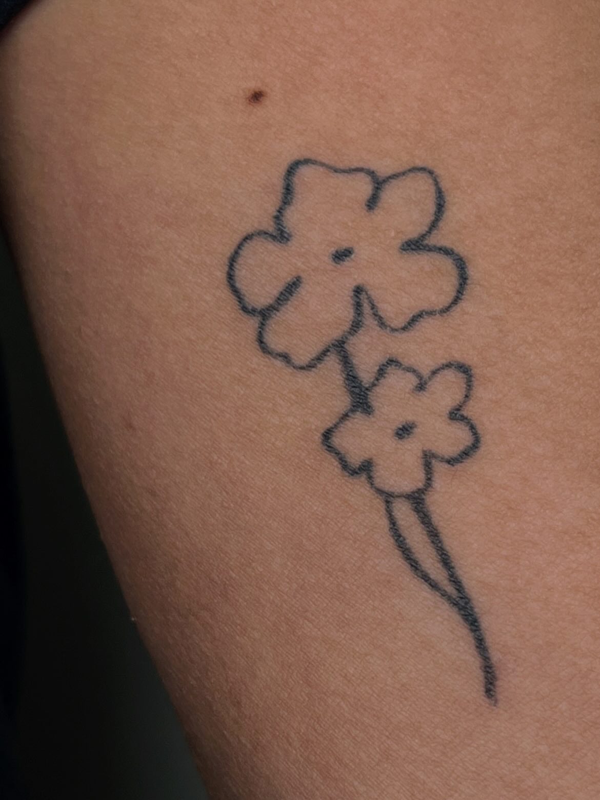 Flower black and grey tattoo on the upper arm by Brooke Elayne