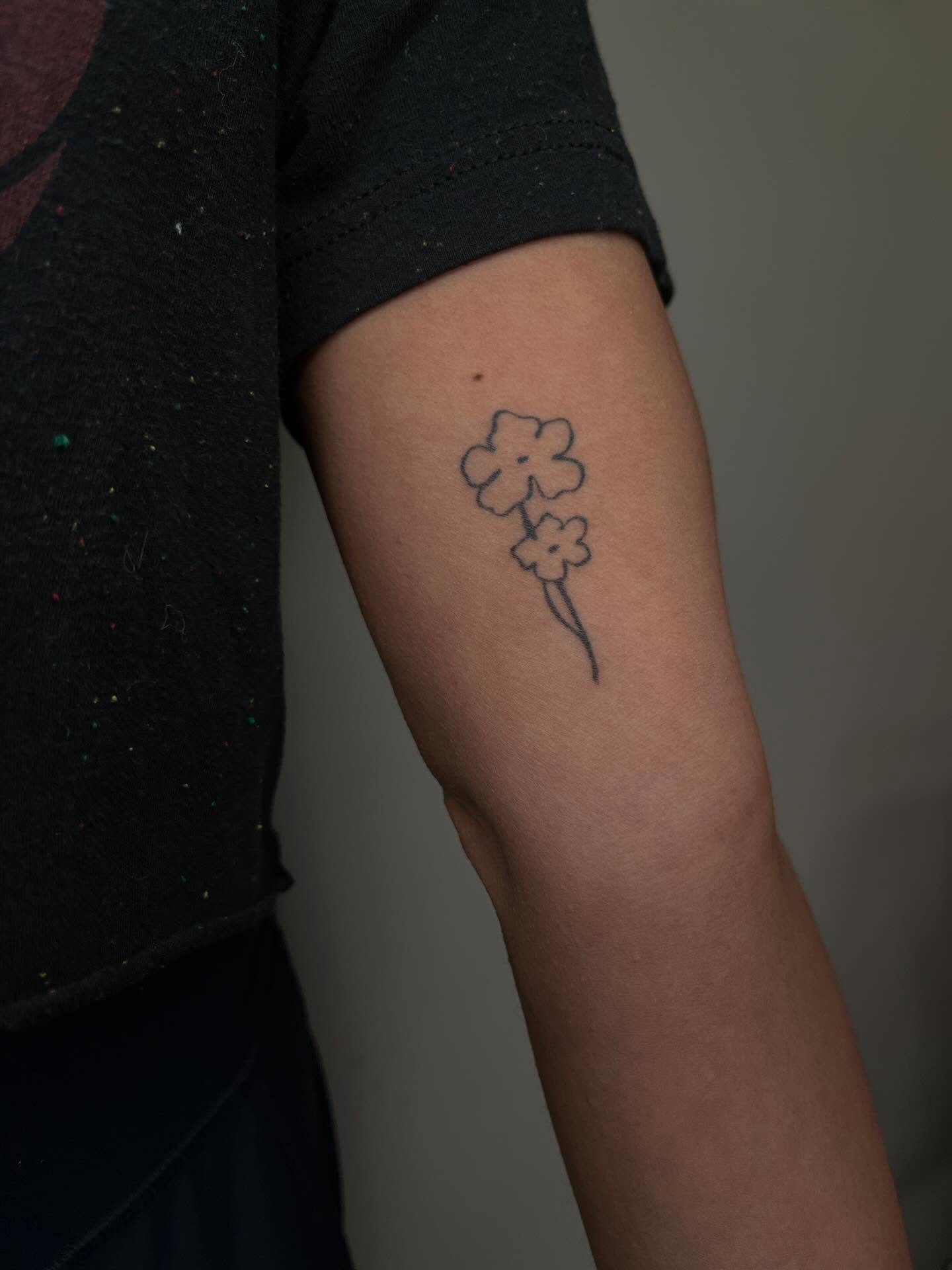 Flowers minimalist tattoo on the forearm by Brooke Elayne