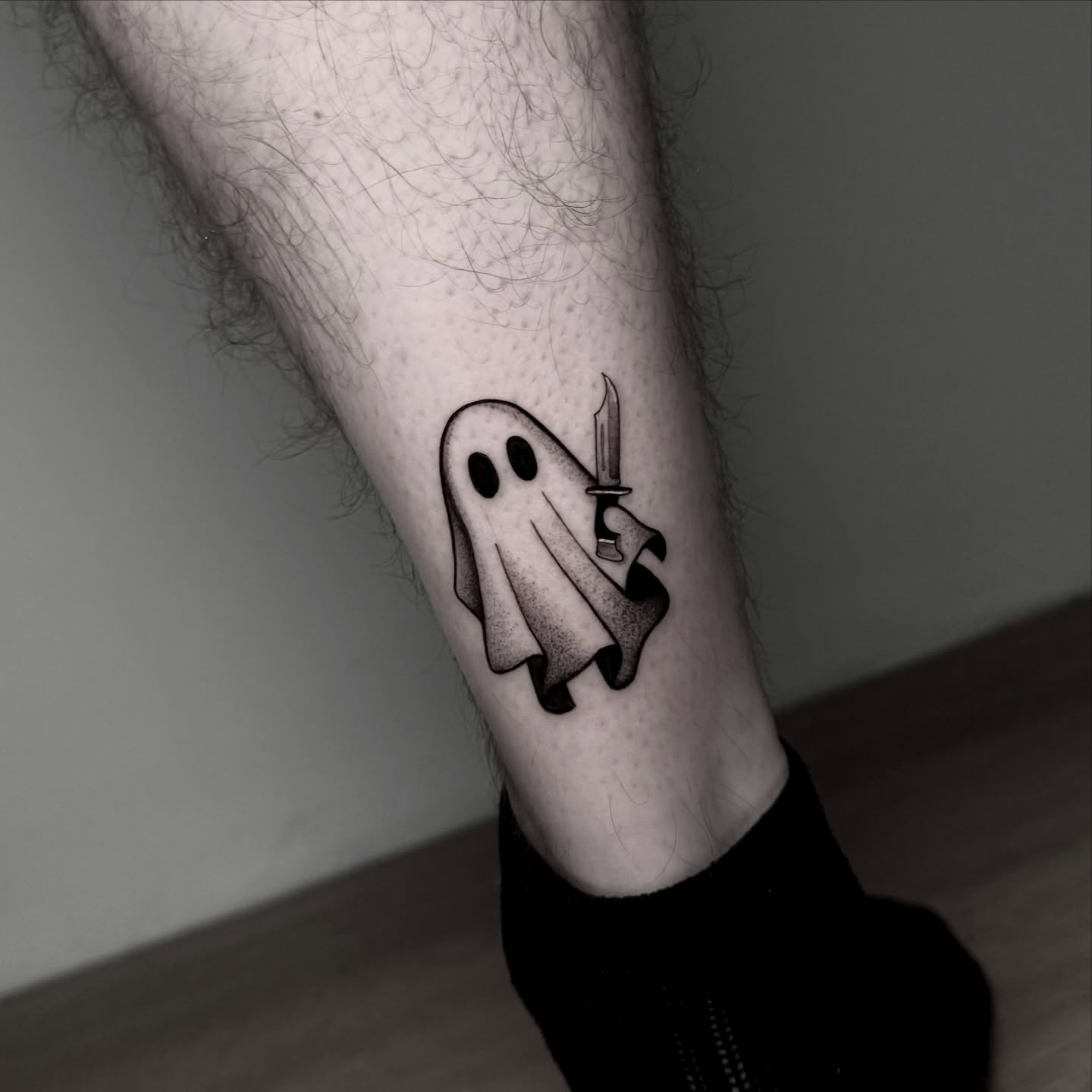 Ghost with knife black and grey tattoo on the forearm by ɪᴠᴏɴɴᴇ