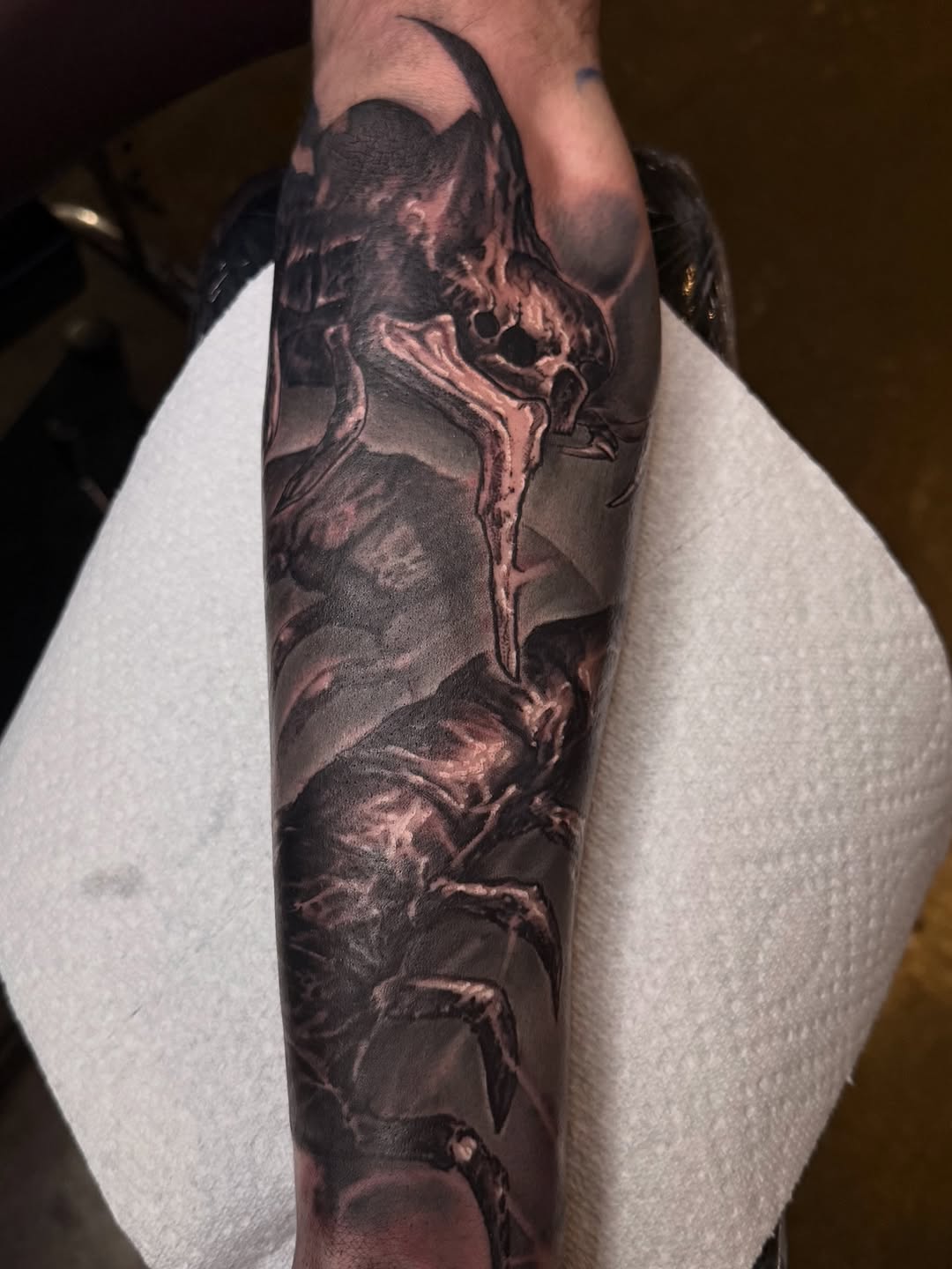Creature realism tattoo on the forearm by Miles Haysmith