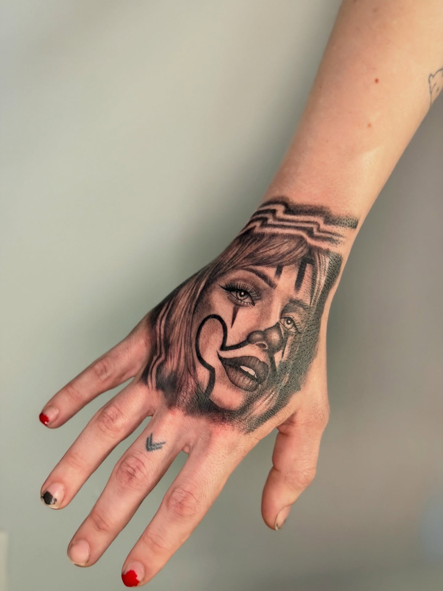 Woman's face realism tattoo on the hand by Mandy Kaur