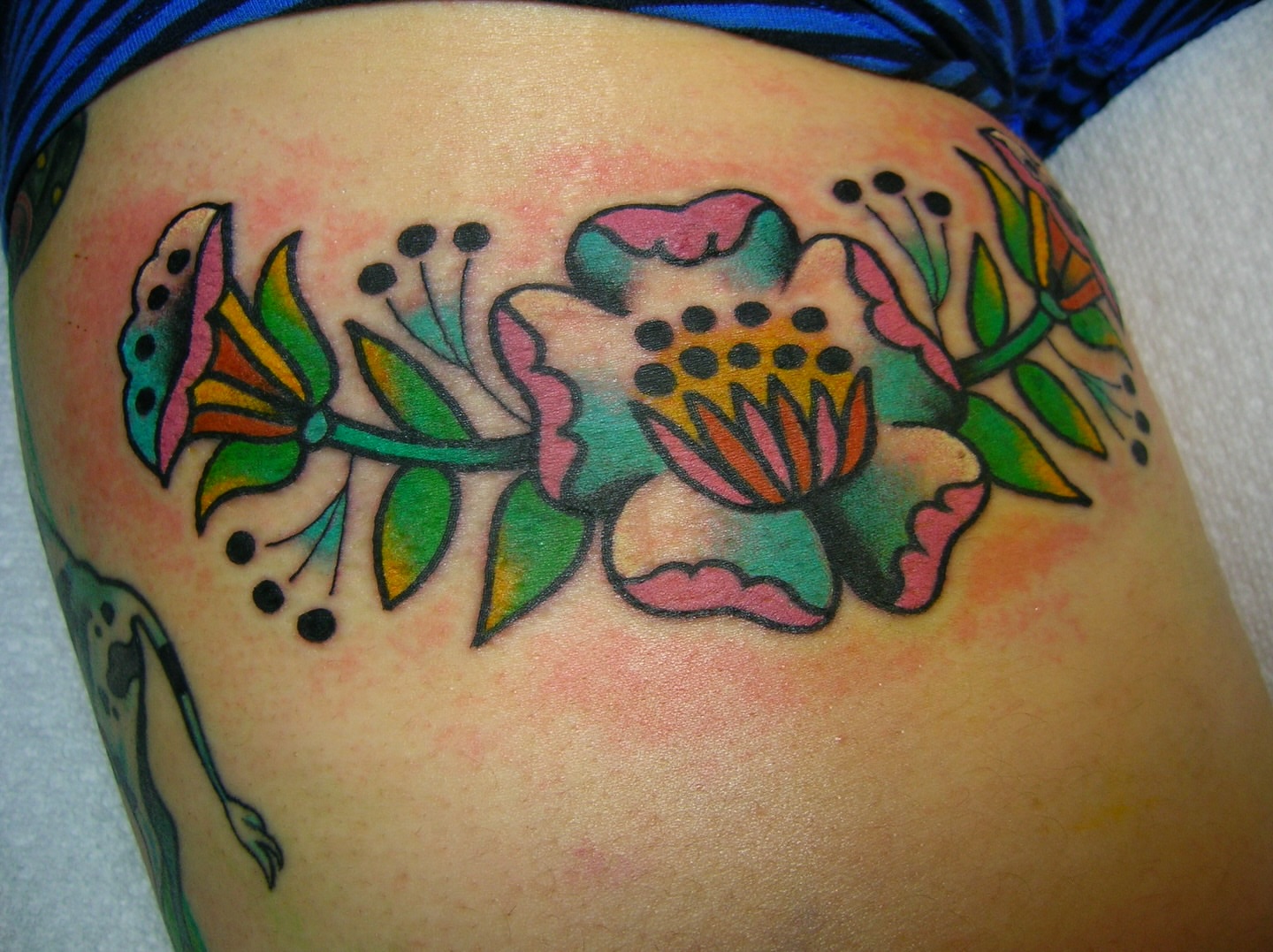Floral arrangement American traditional tattoo on the thigh by edith🌷, Murfreesboro, Tennessee