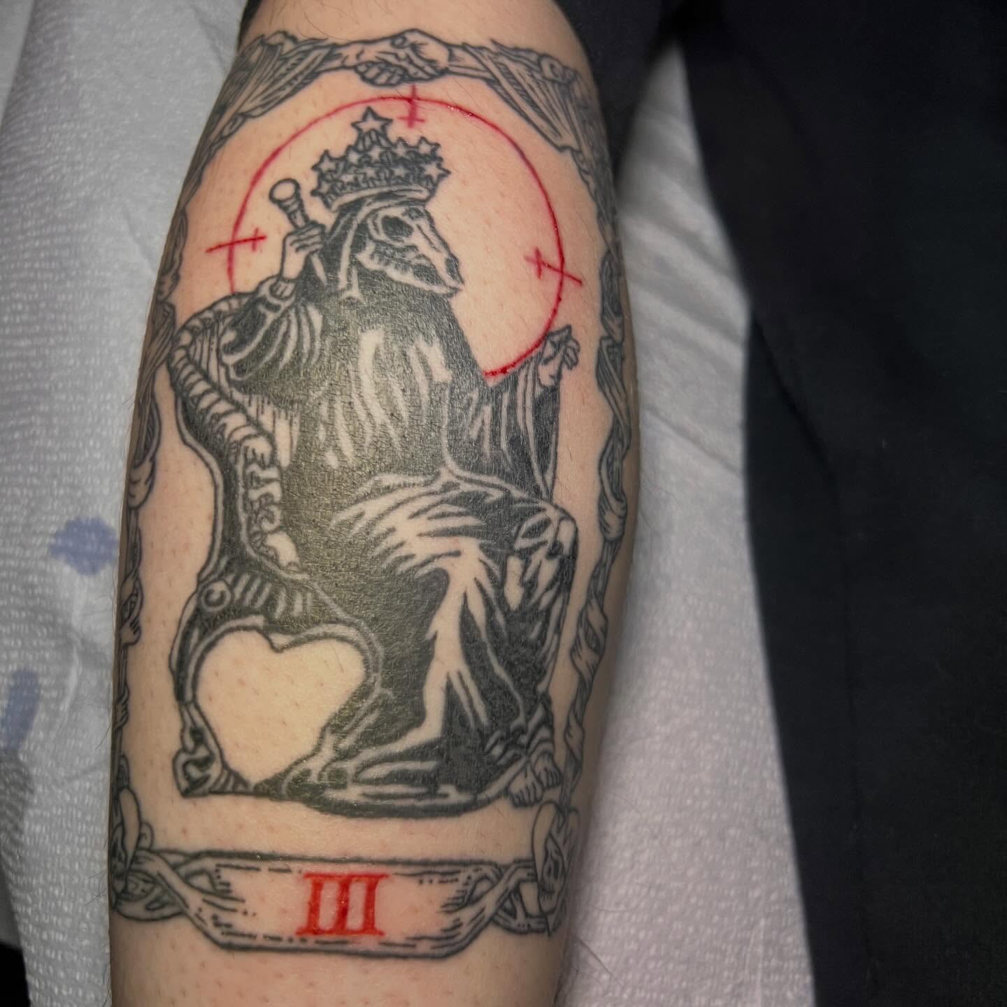 King on throne black and grey tattoo on the forearm by Jason Middelton