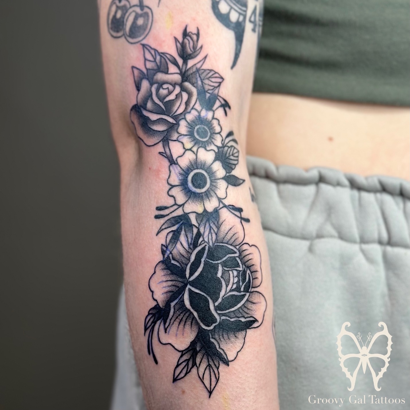 Floral bouquet black and grey tattoo on the forearm by Groovy P