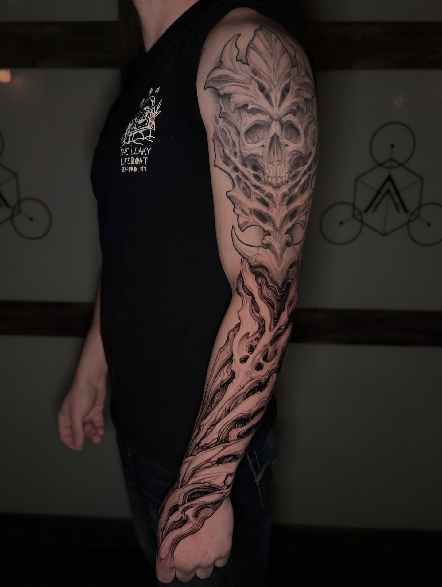 Skull with vine realism tattoo on the forearm by Dominick Cali, East Islip, New York
