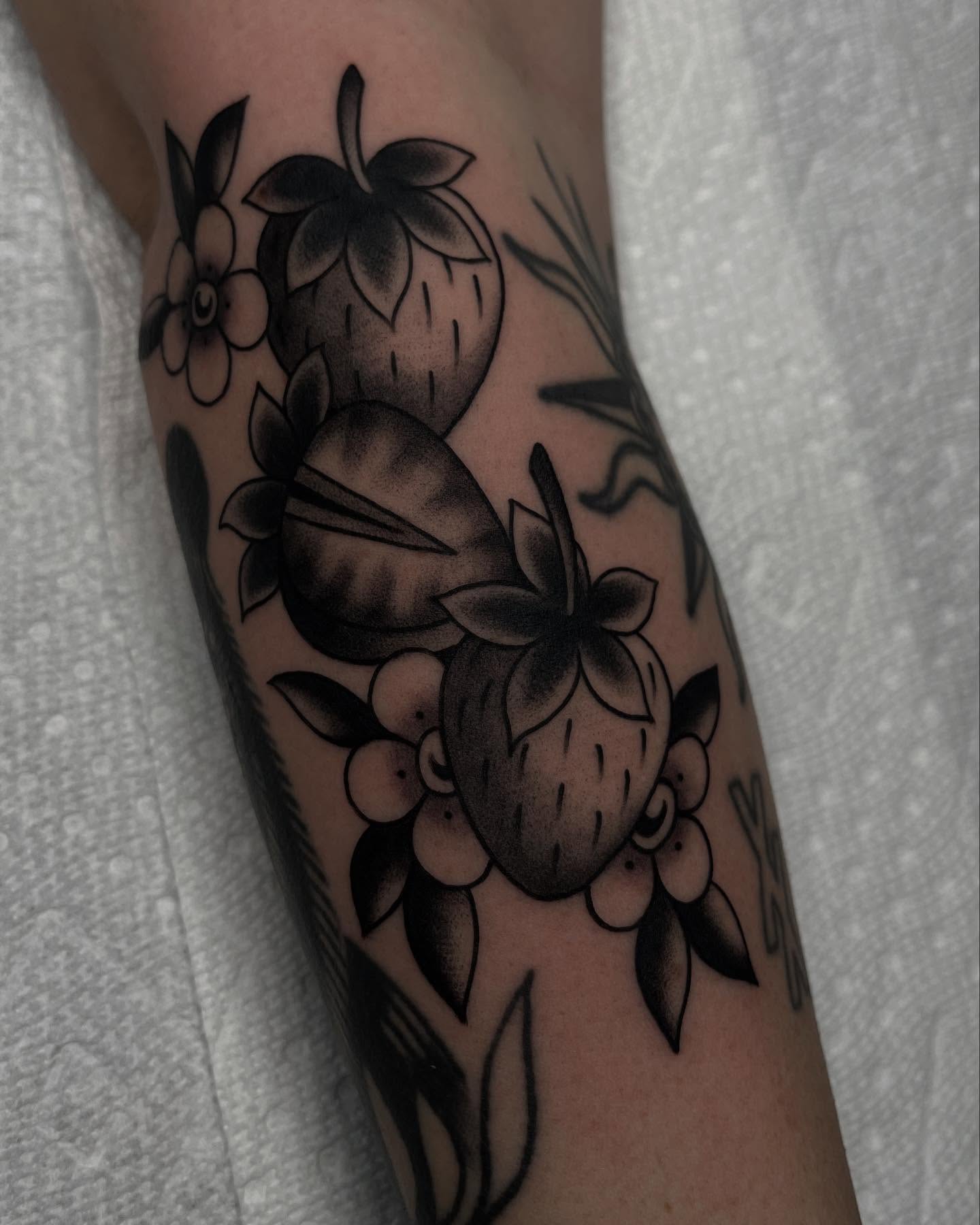 Strawberries and flowers American traditional tattoo on the forearm by Kayla Faircloth, Charlotte, North Carolina