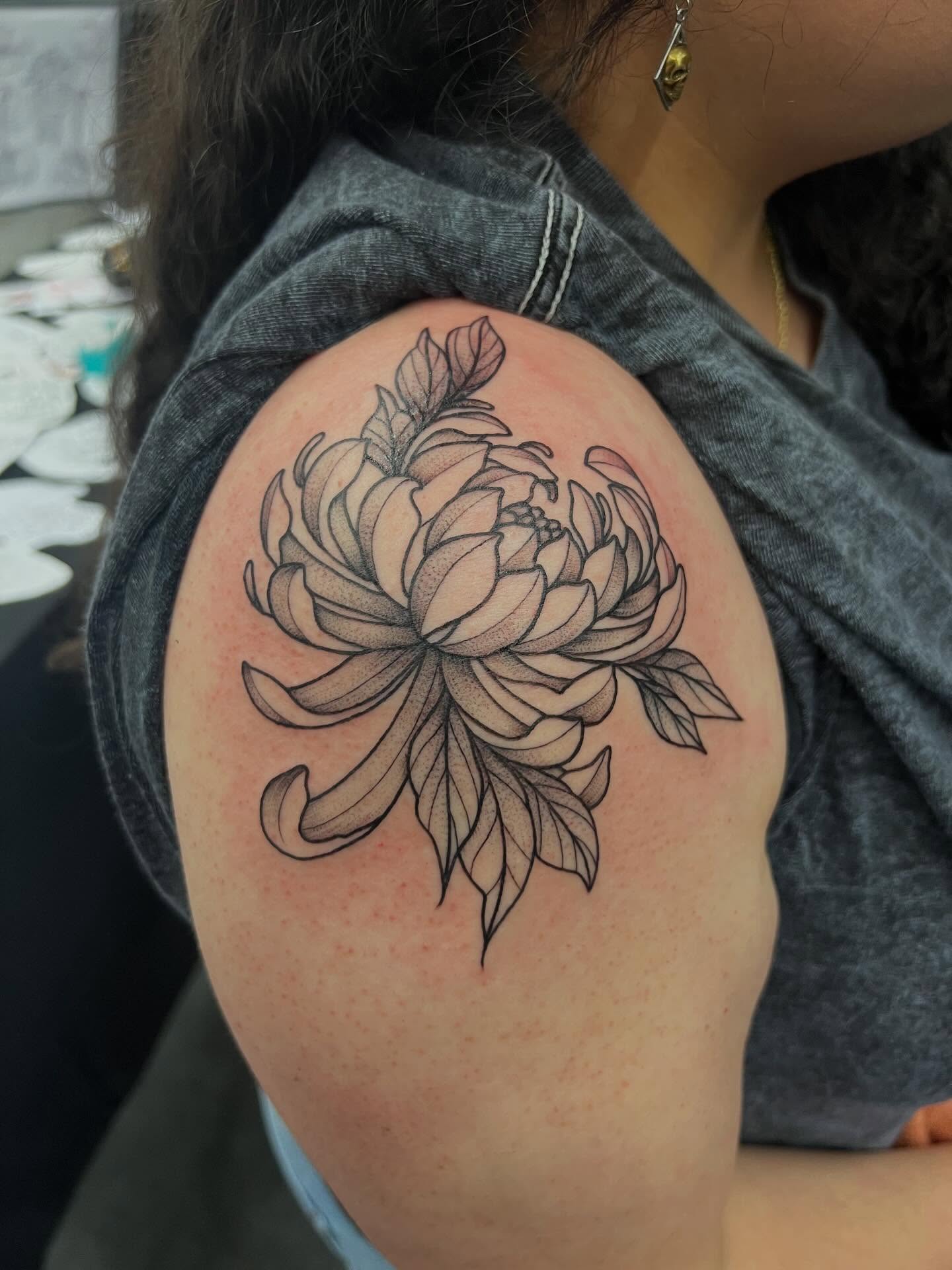 Chrysanthemum dotwork tattoo on the shoulder by Baung Ben
