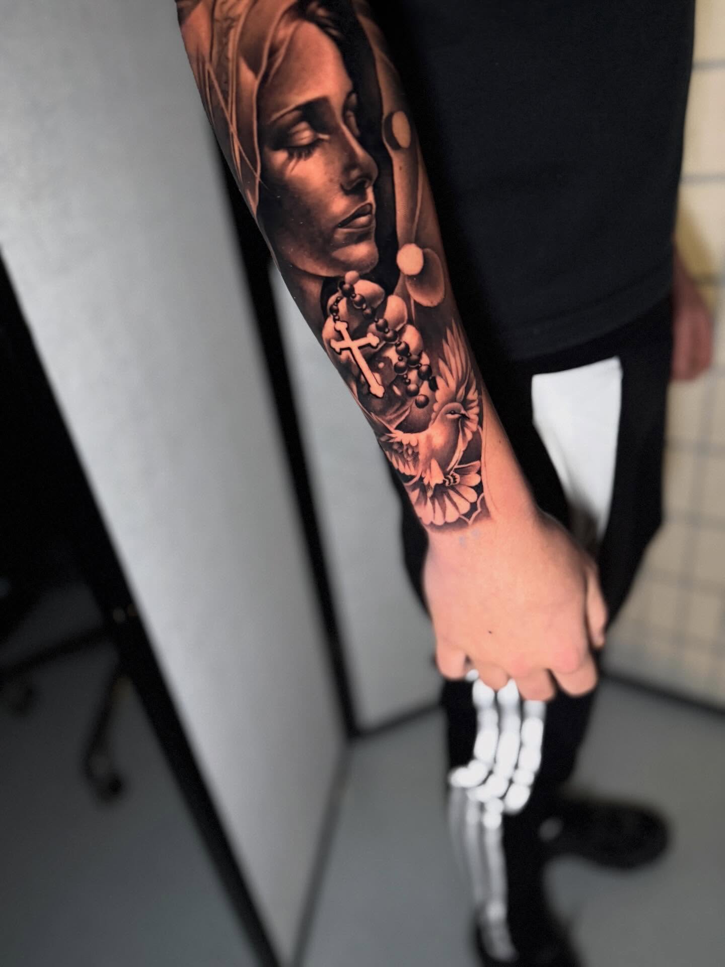 Religious figure realism tattoo on the forearm by Miles Johnson