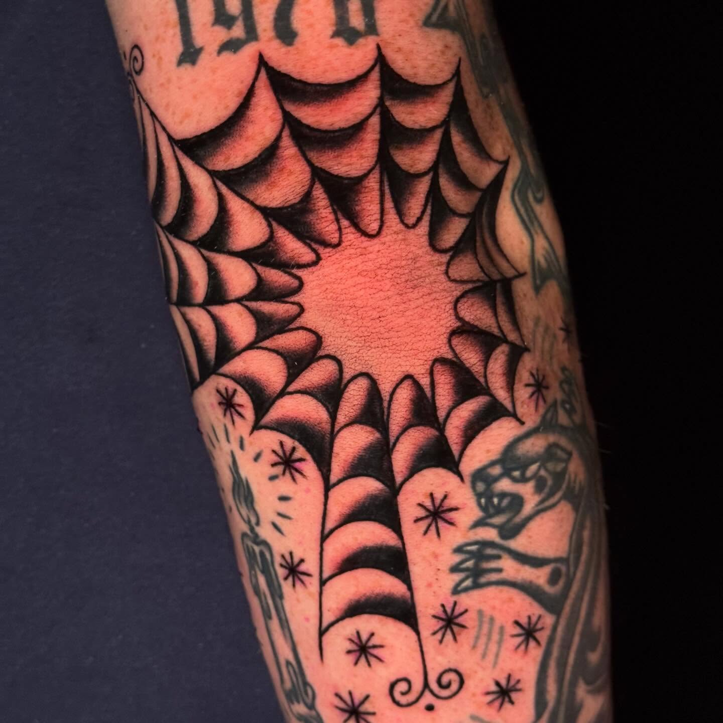 Spiral pattern American traditional tattoo on the forearm by Mallory Brown