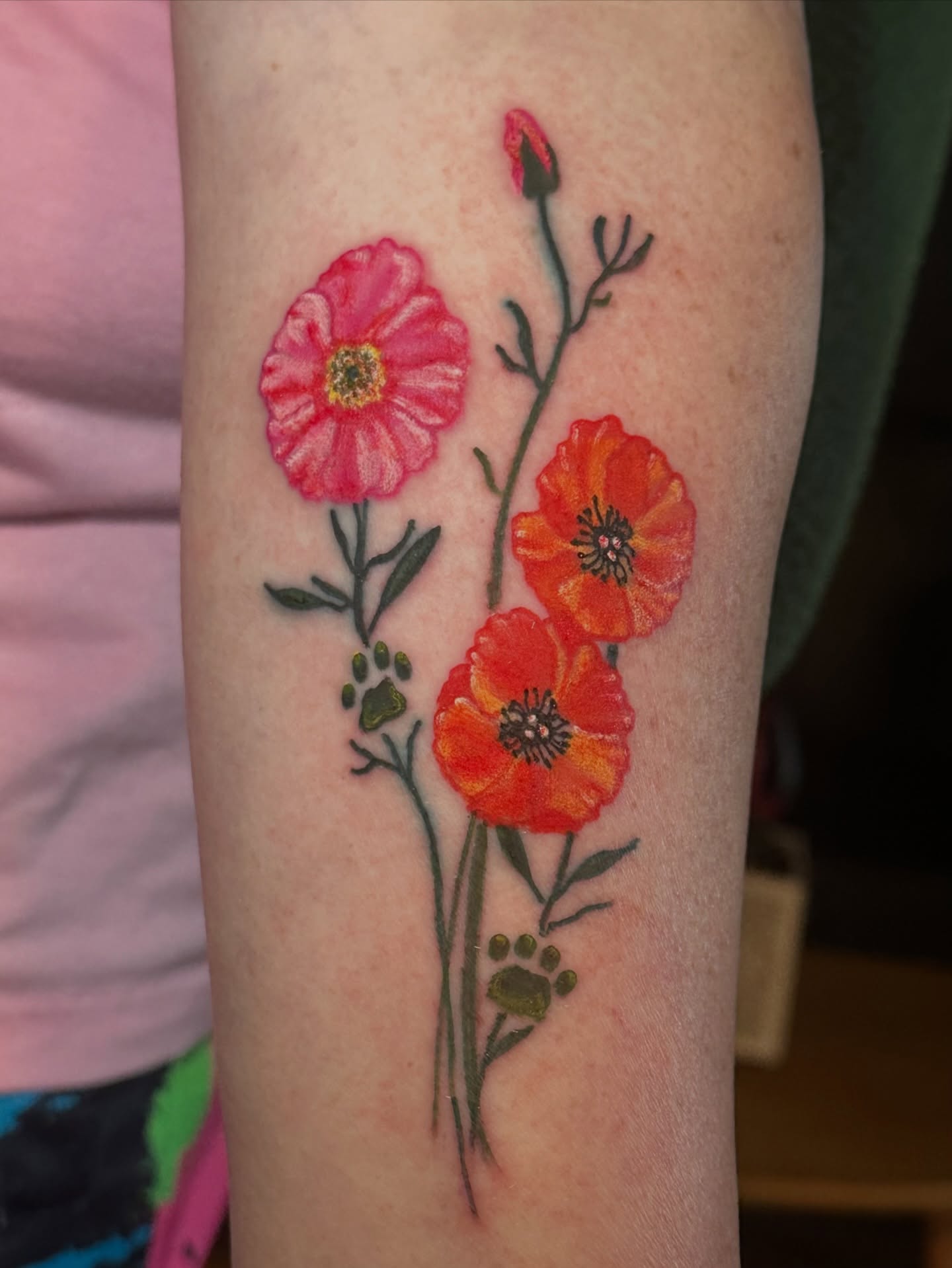 Flowers watercolor tattoo on the forearm by Cory Wasmund (blue check)