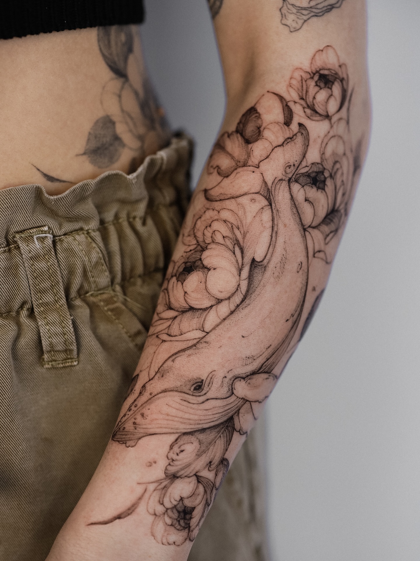 Whale and flowers black and grey tattoo on the forearm by Maria