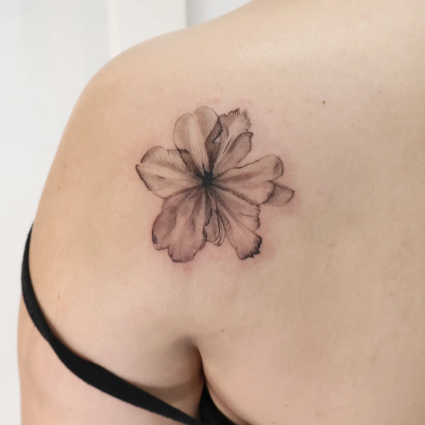 Flower black and grey tattoo on the shoulder by Joc