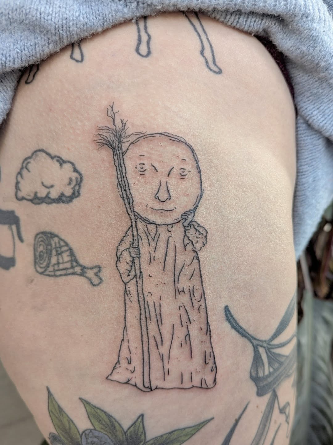 Old man with staff black and grey tattoo on the thigh by Patricio