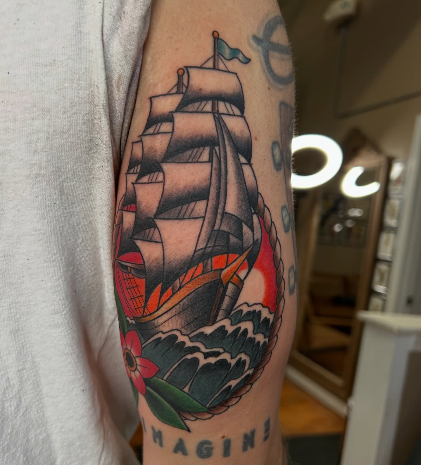 Ship sailing through waves American traditional tattoo on the forearm by Alex Byrne