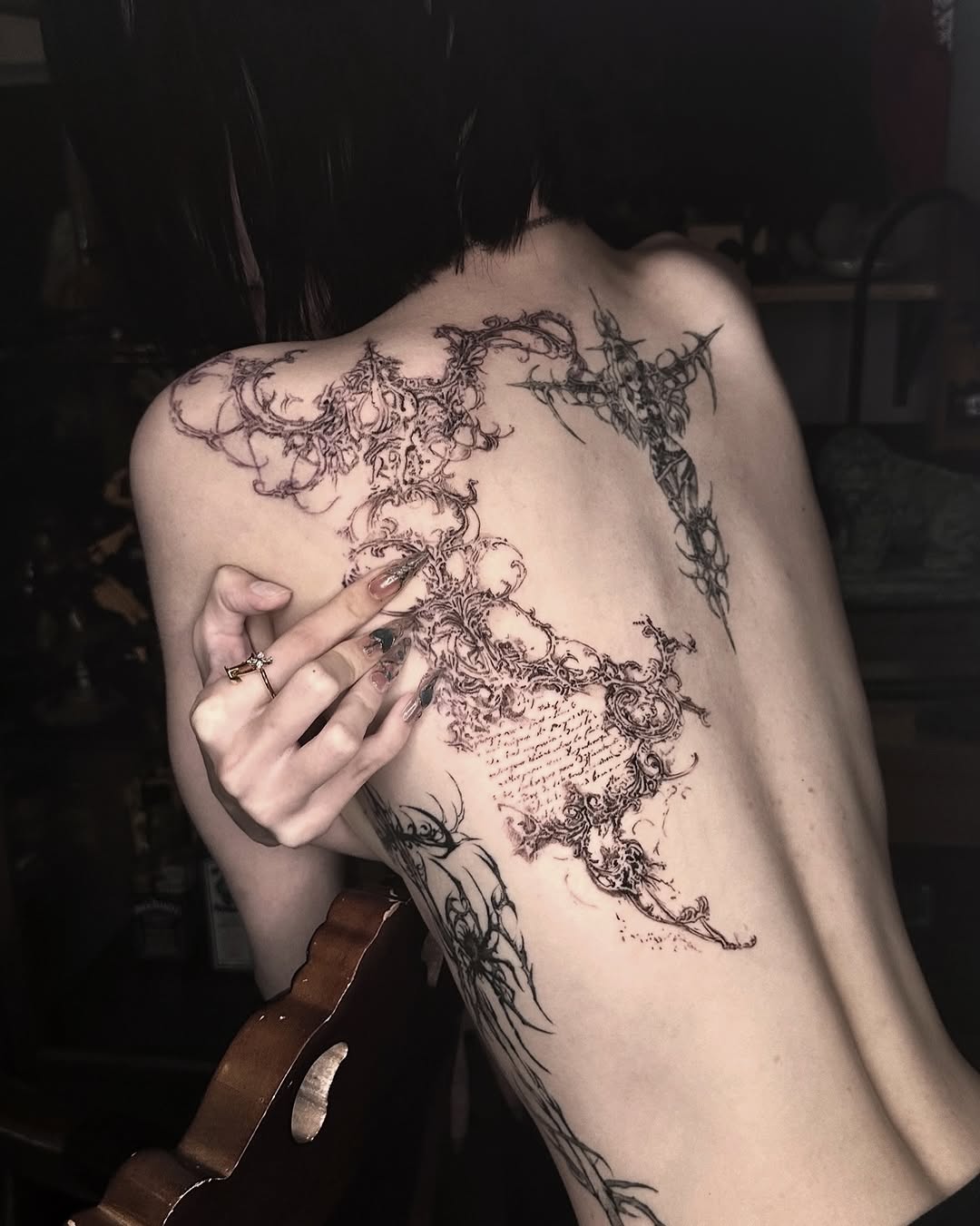 Ornamental script blackwork tattoo on the back by @ashencoil