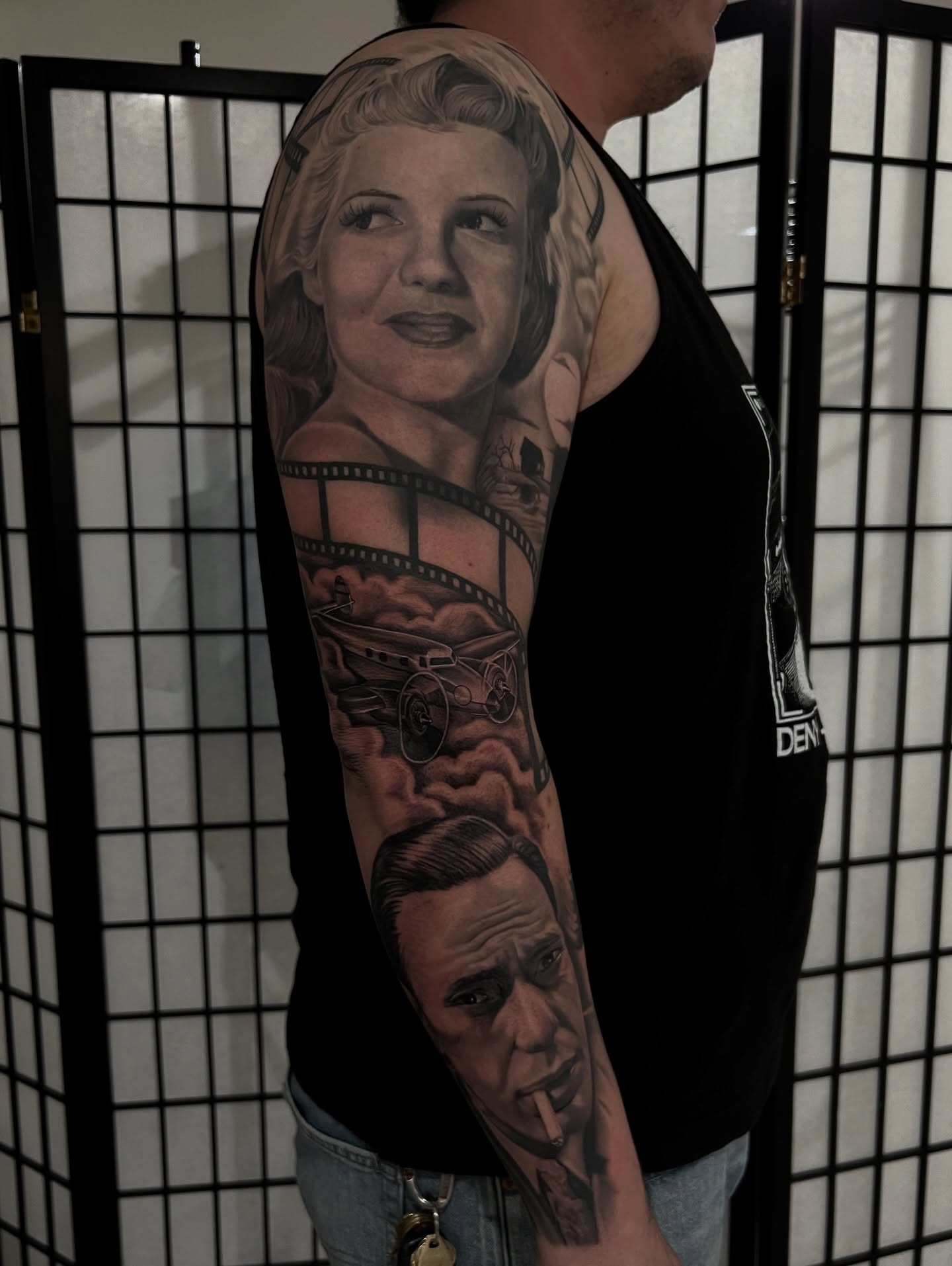 Filmstrip and characters realism tattoo on the upper arm by Nick Bridwell, Downey, California