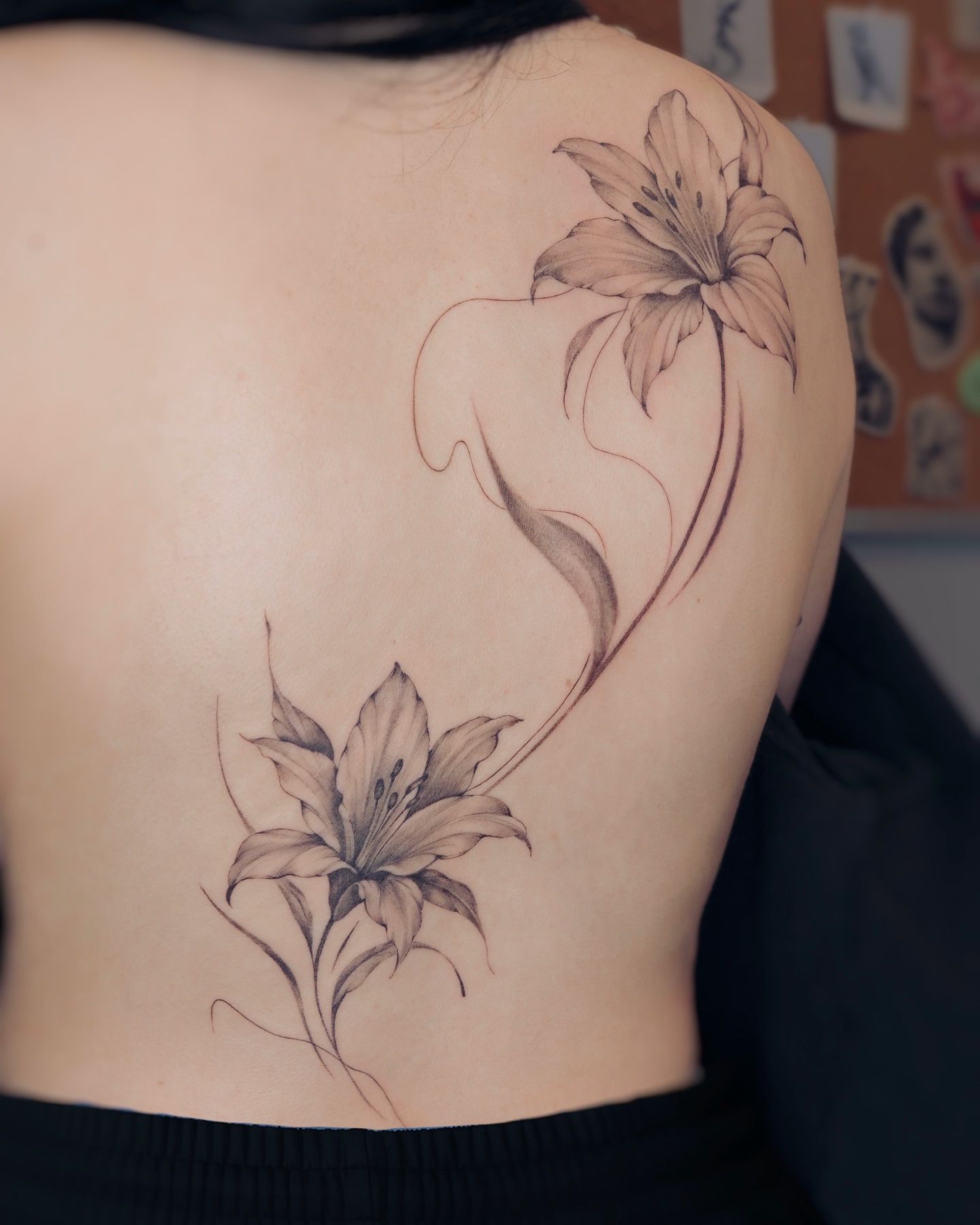 Lily black and grey tattoo on the shoulder by Alina 🌙 Tattoo in Calgary 🇨🇦