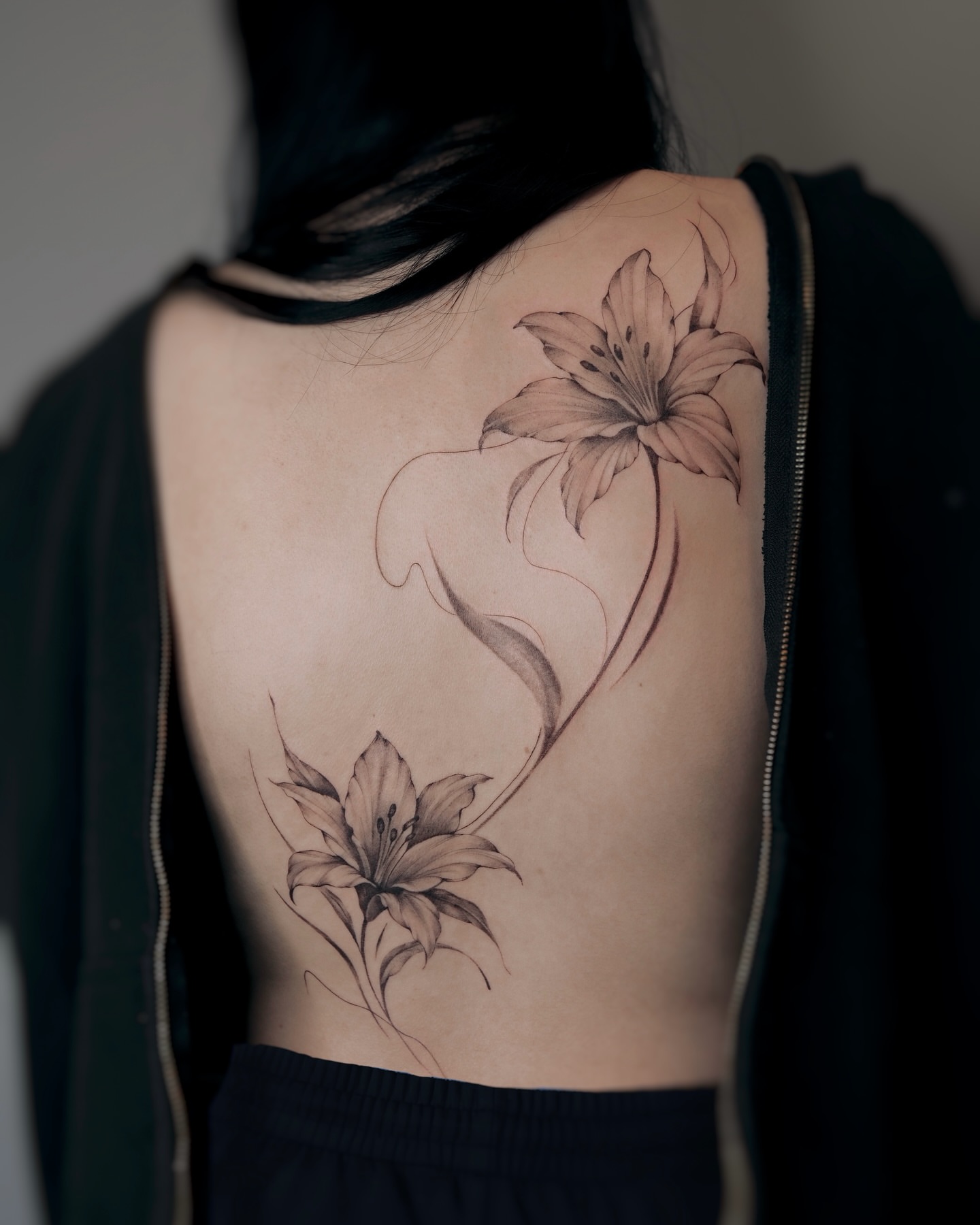 Lilies realism tattoo on the back by Alina 🌙 Tattoo in Calgary 🇨🇦