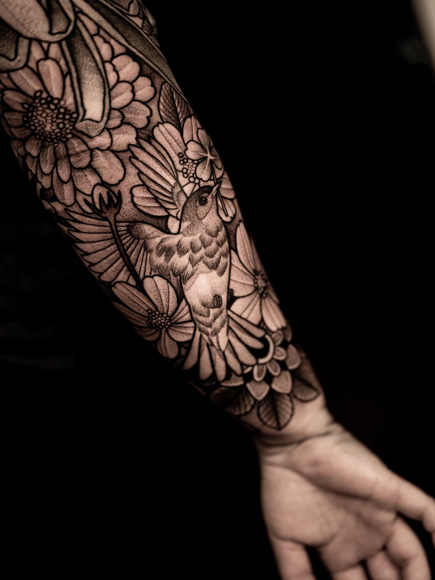 Bird and flowers realism tattoo on the forearm by Craig St Peter, Kansas City, Missouri