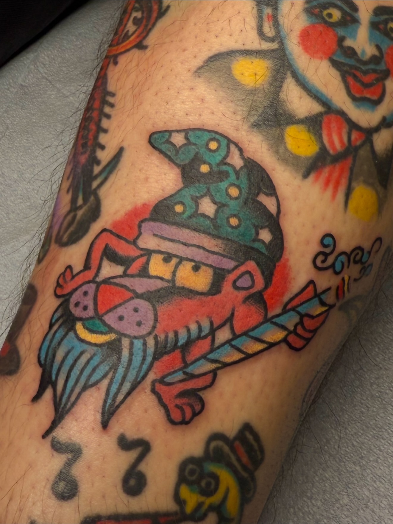 Clown and frog American traditional tattoo on the forearm by Zac Clark