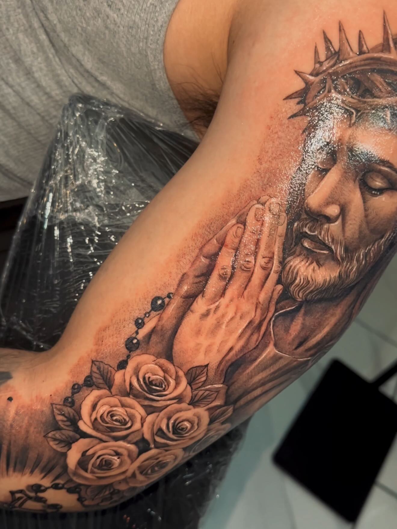 Praying hands with Jesus realism tattoo on the forearm by Adrian gonzalez...