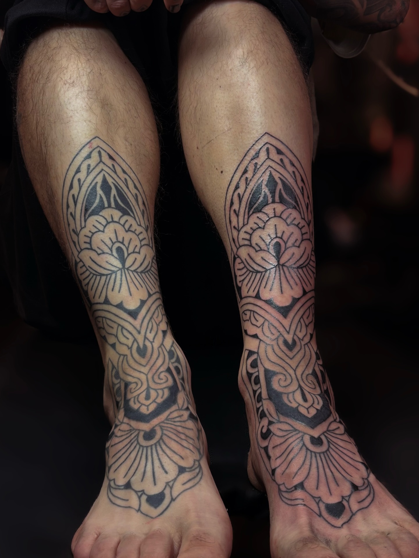 Floral design black and grey tattoo on the calf by Storm Smith
