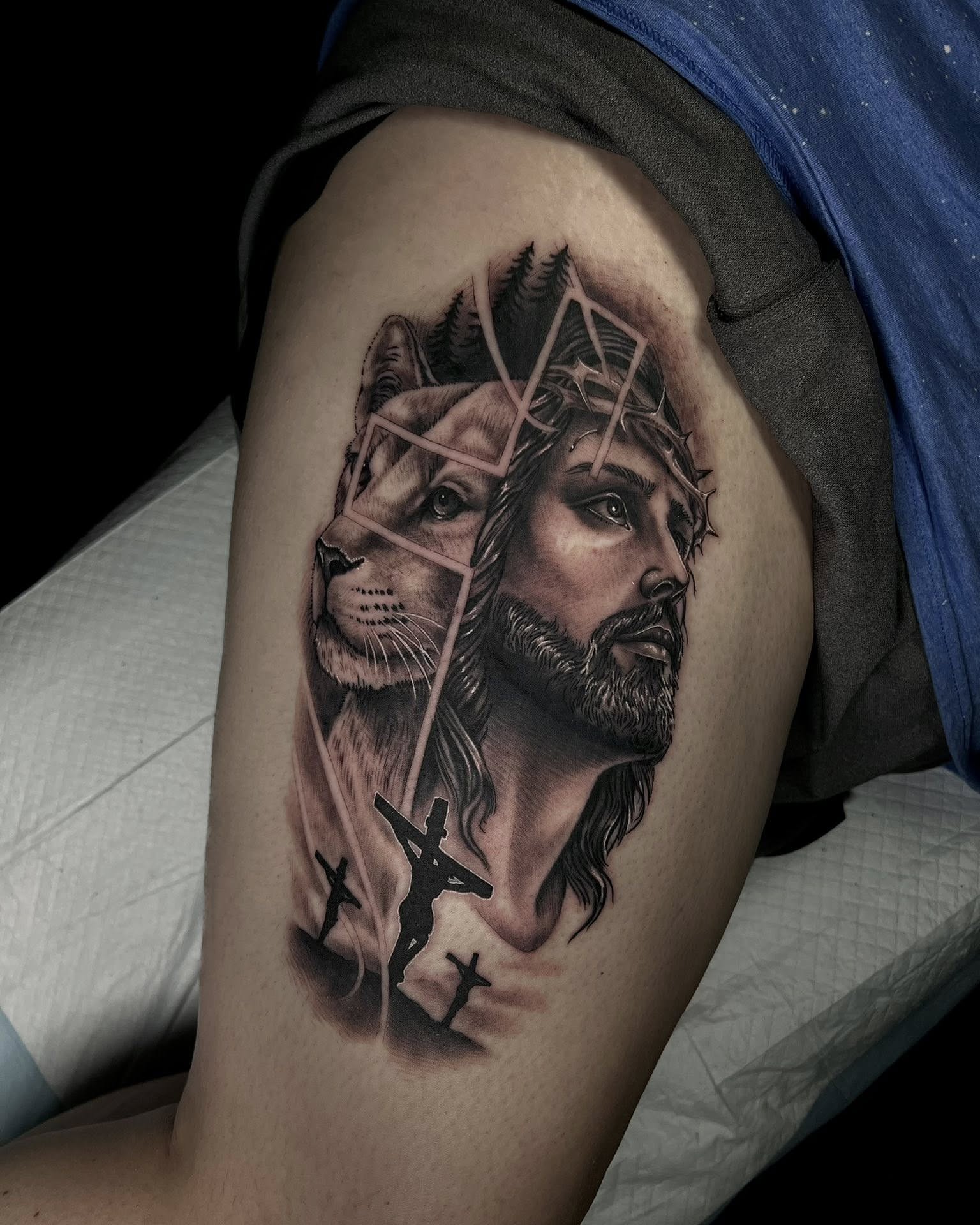Lion and Jesus realism tattoo on the thigh by Corey Bailey, Stanton, Kentucky
