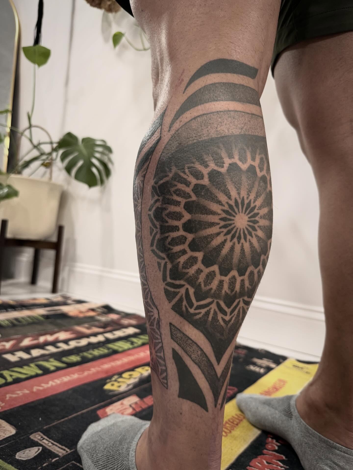 Geometric mandala dotwork tattoo on the calf by Shannon Misitano