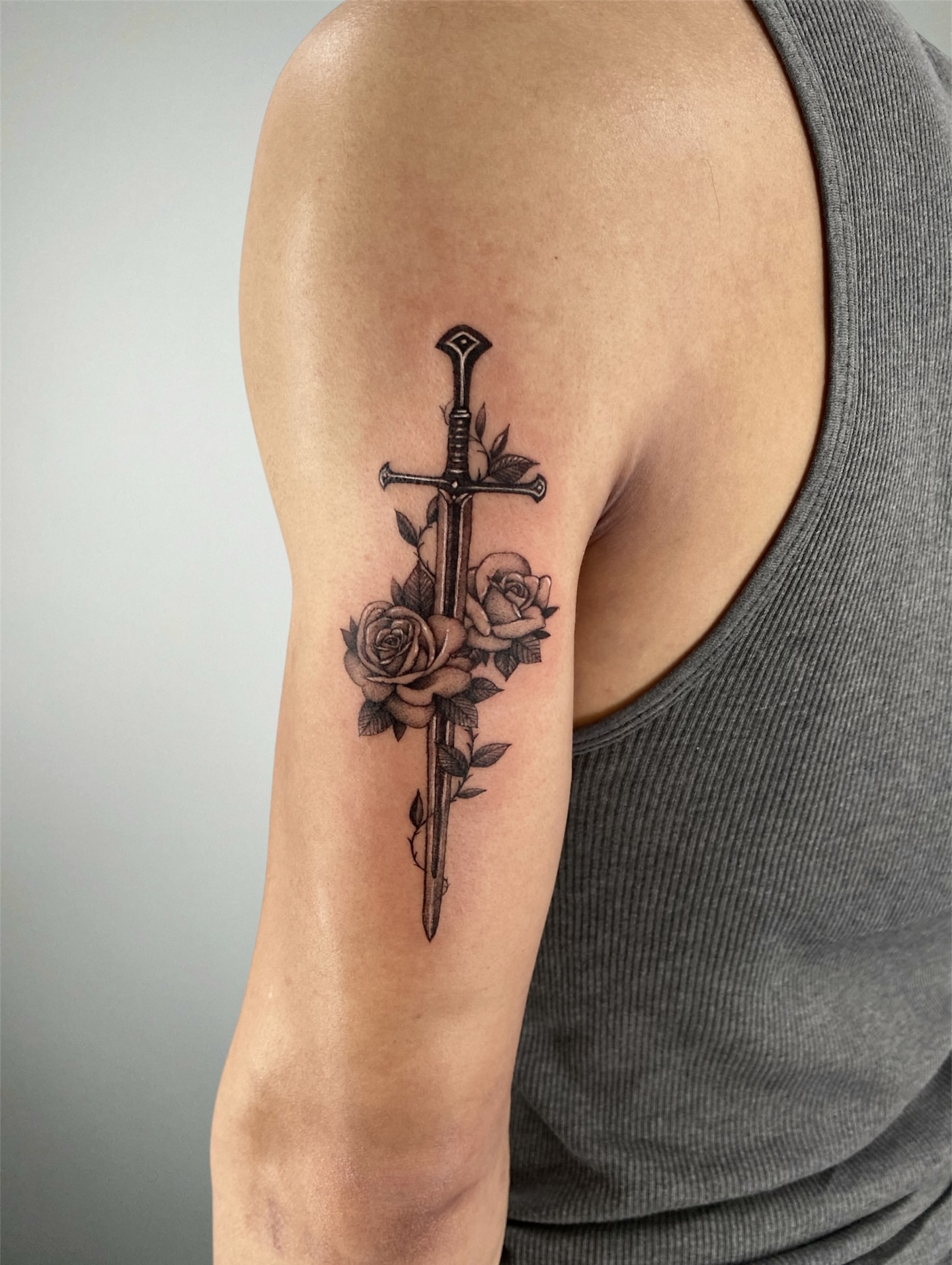 Sword and roses black and grey tattoo on the forearm by ⚒dptattoos ⚒, East Williamsburg, Brooklyn