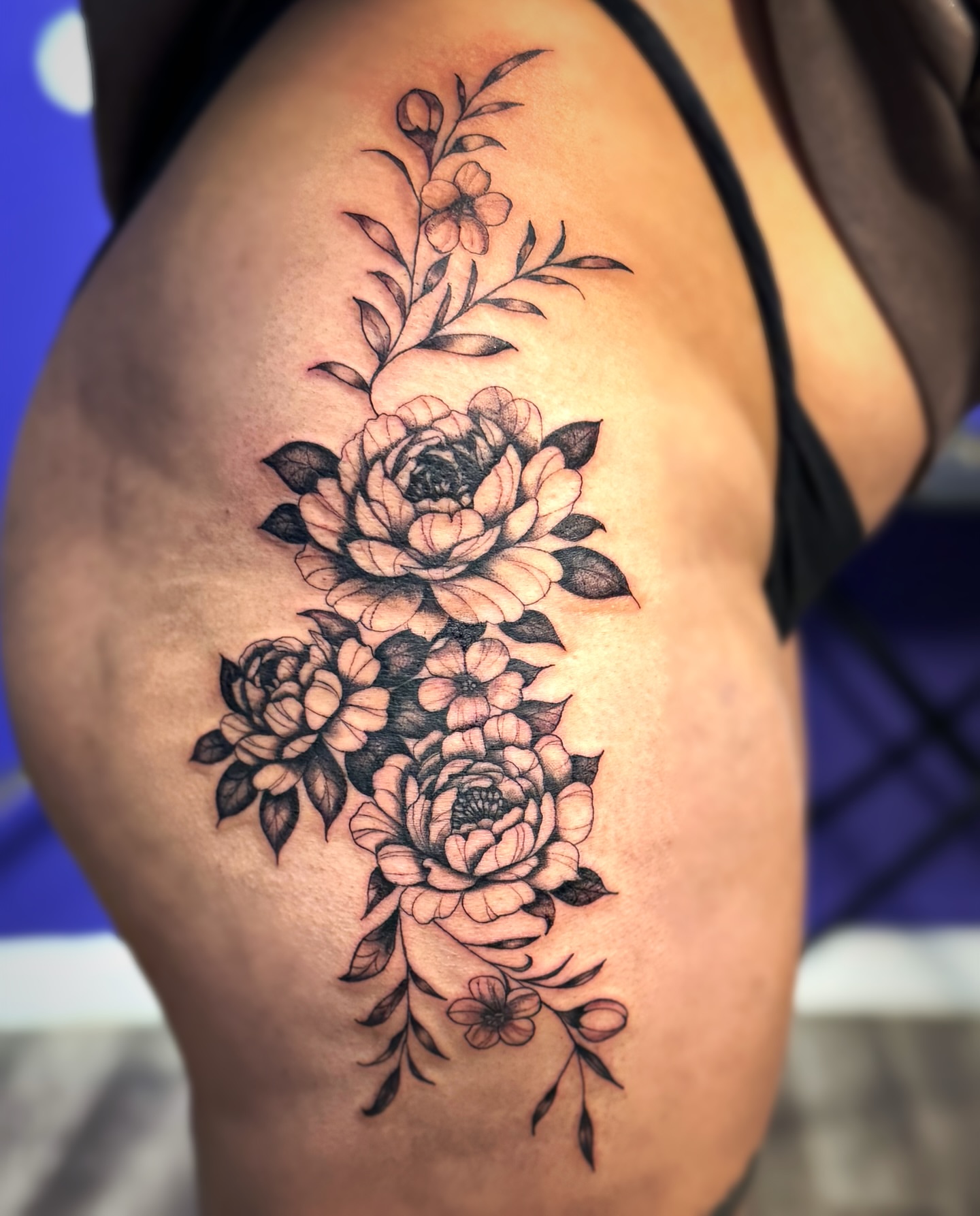 Floral bouquet black and grey tattoo on the thigh by Kate