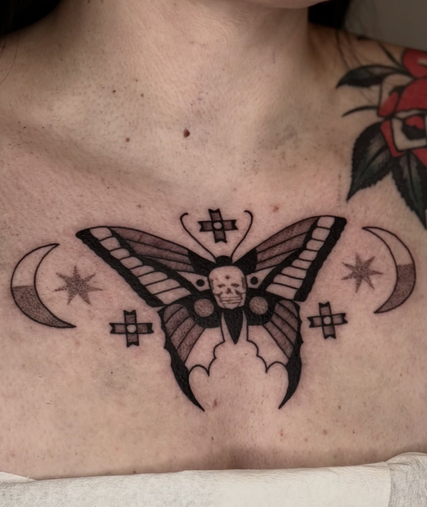 Butterfly with skull black and grey tattoo on the chest by Maks