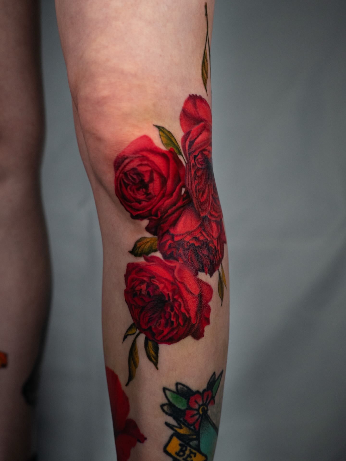 Red roses realism tattoo on the forearm by Nate