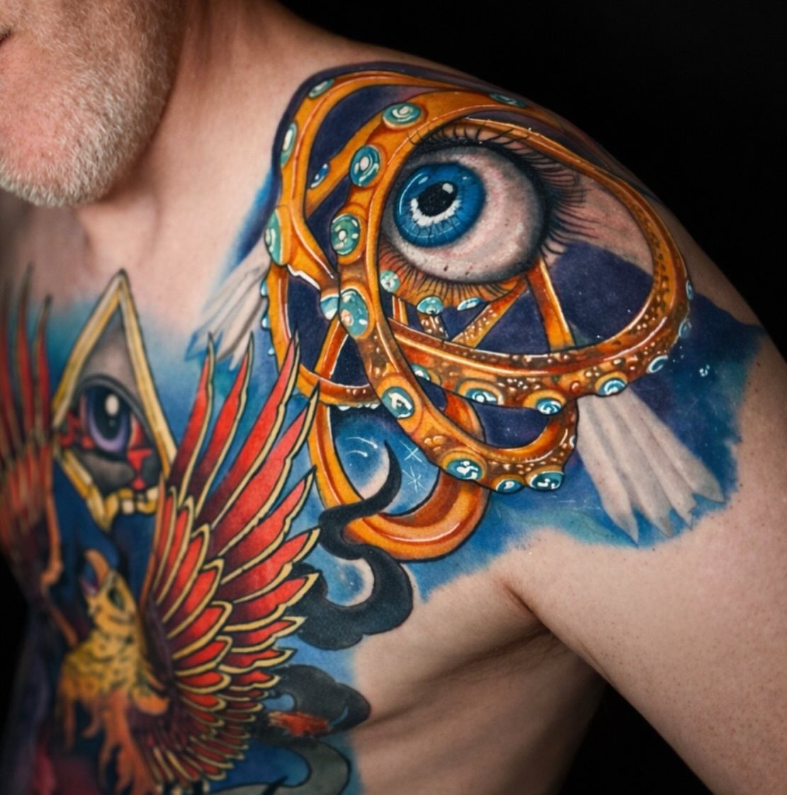 Eye and octopus tentacle geometric tattoo on the shoulder by Shake_tatts