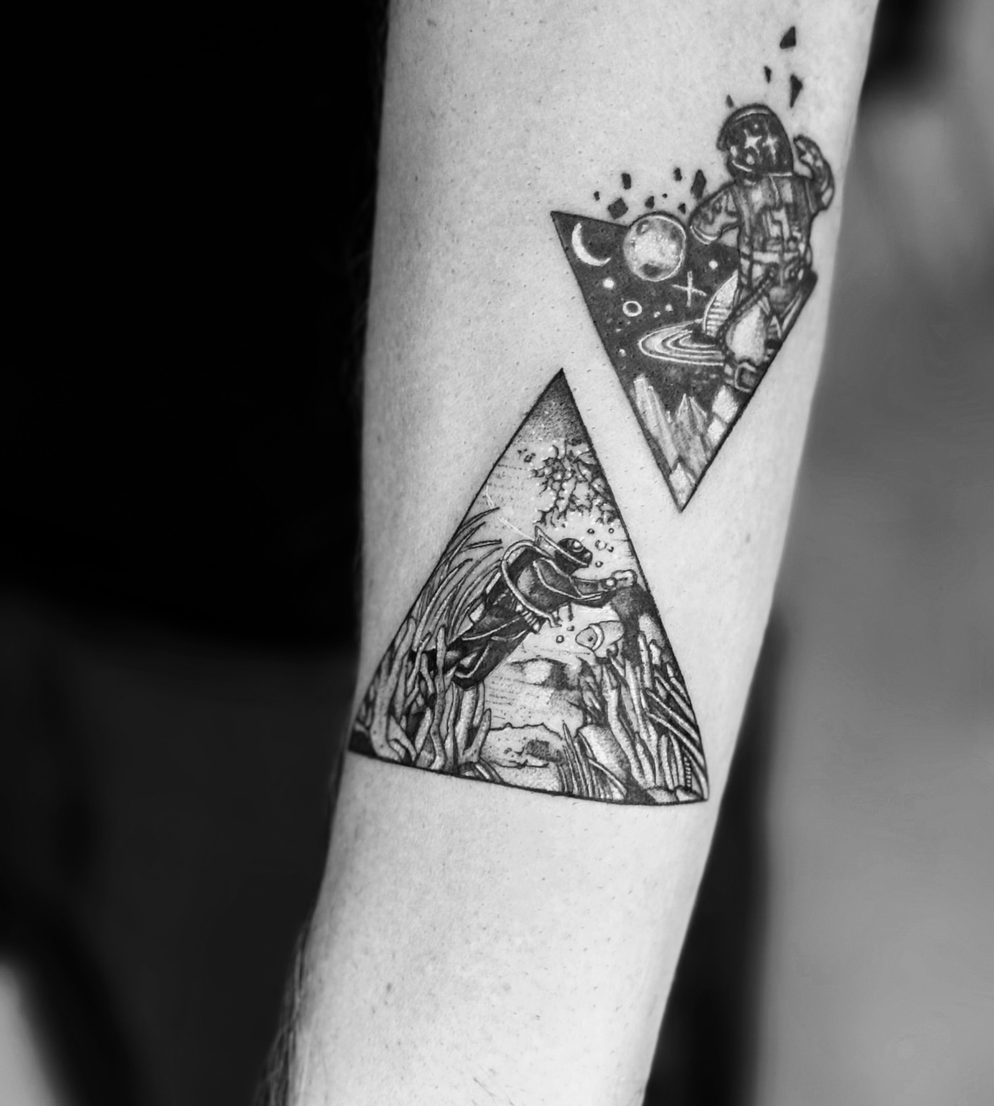 Astronauts in space geometric tattoo on the forearm by MJ