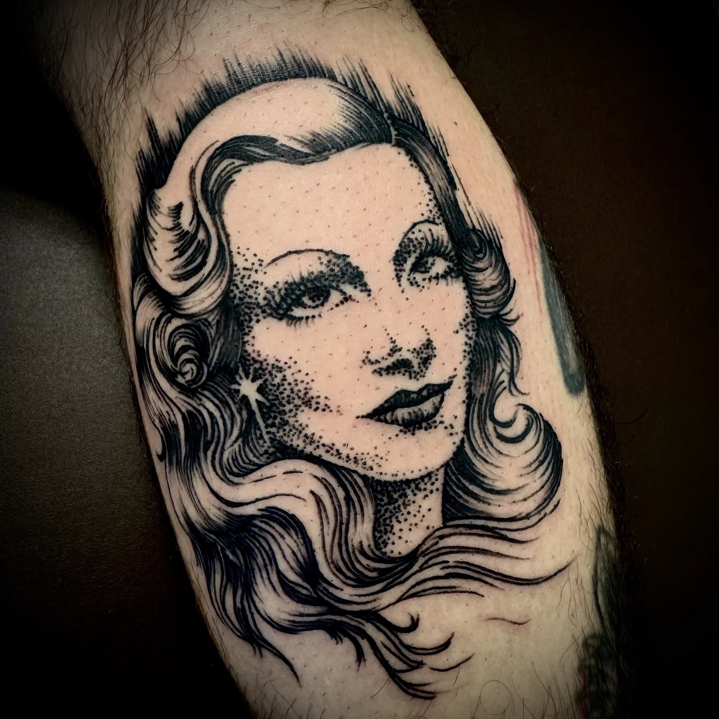 Woman's face dotwork tattoo on the forearm by Kristen