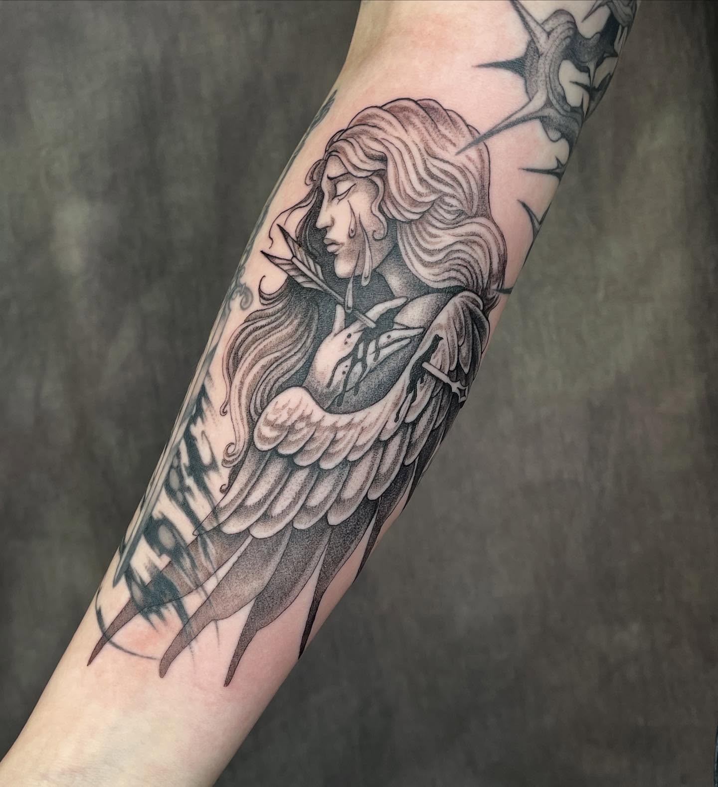 Angel with arrow realism tattoo on the forearm by 𝖂𝖍𝖆𝖙𝕽𝖊𝖎𝖑𝖊𝖞