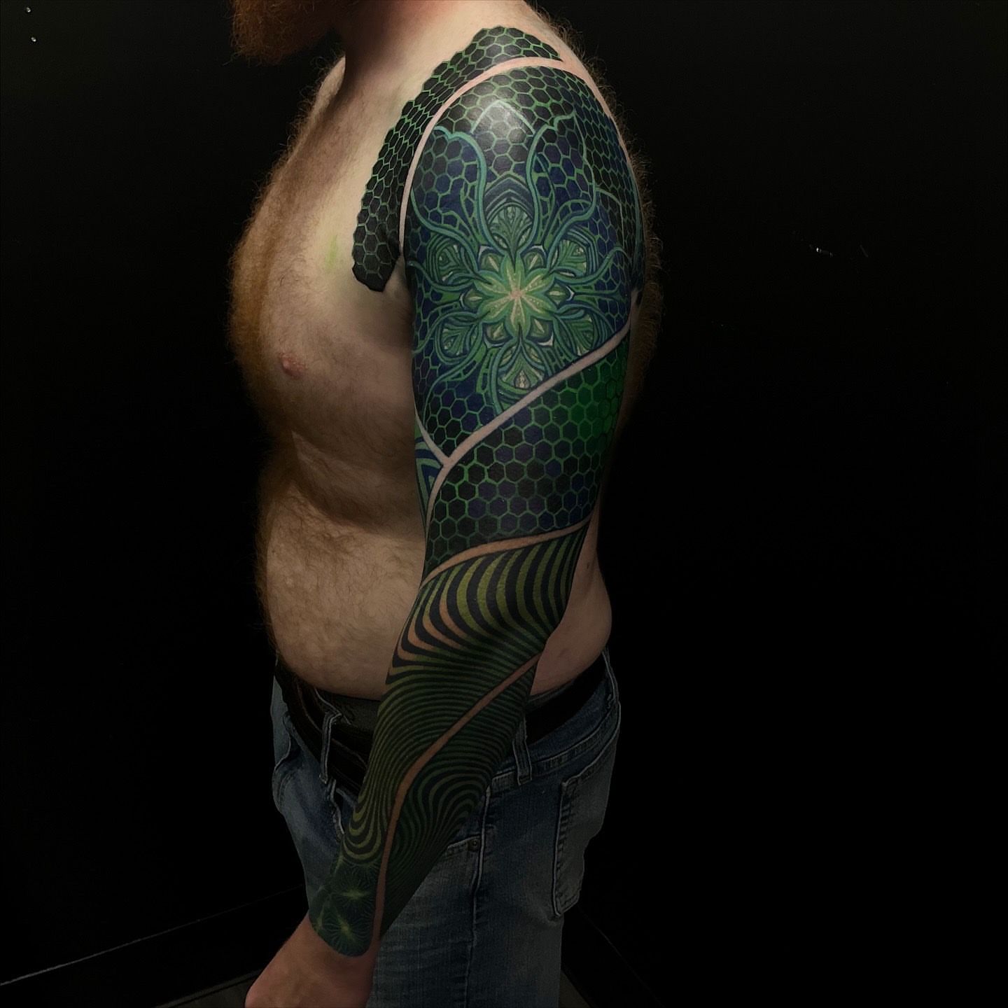 Geometric mandala geometric tattoo on the upper arm by Jordan Rookus